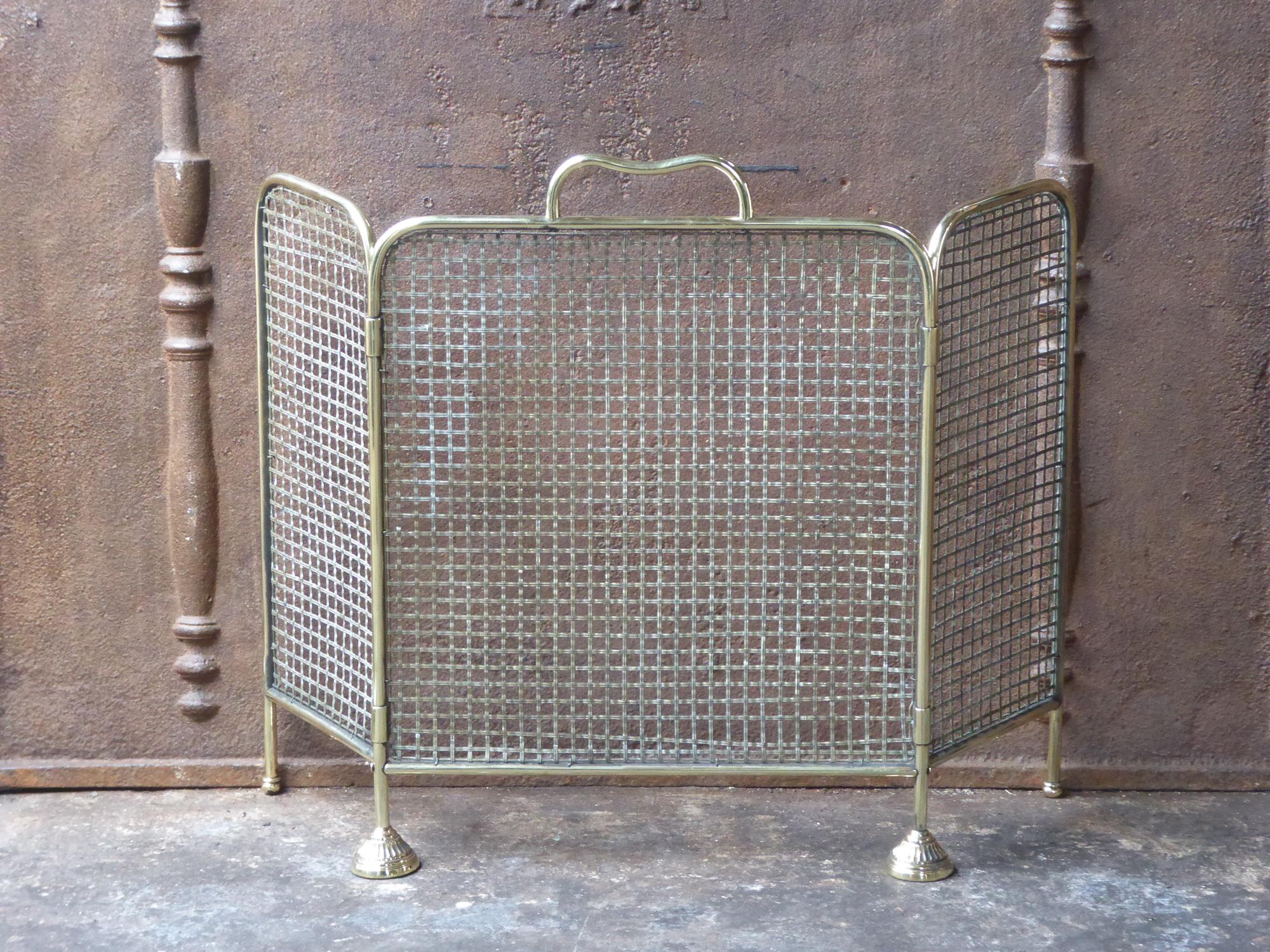 19th century English Victorian fireplace screen made of polished brass and iron mesh.







      