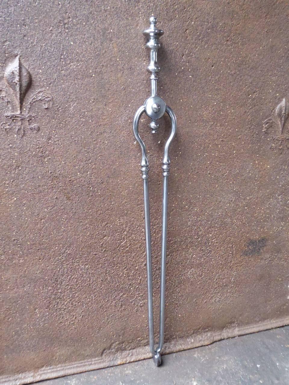 19th century English Victorian fireplace tongs made of polished steel.

We have a unique and specialized collection of antique and used fireplace accessories consisting of more than 1000 listings at 1stdibs. Amongst others we always have 300+
