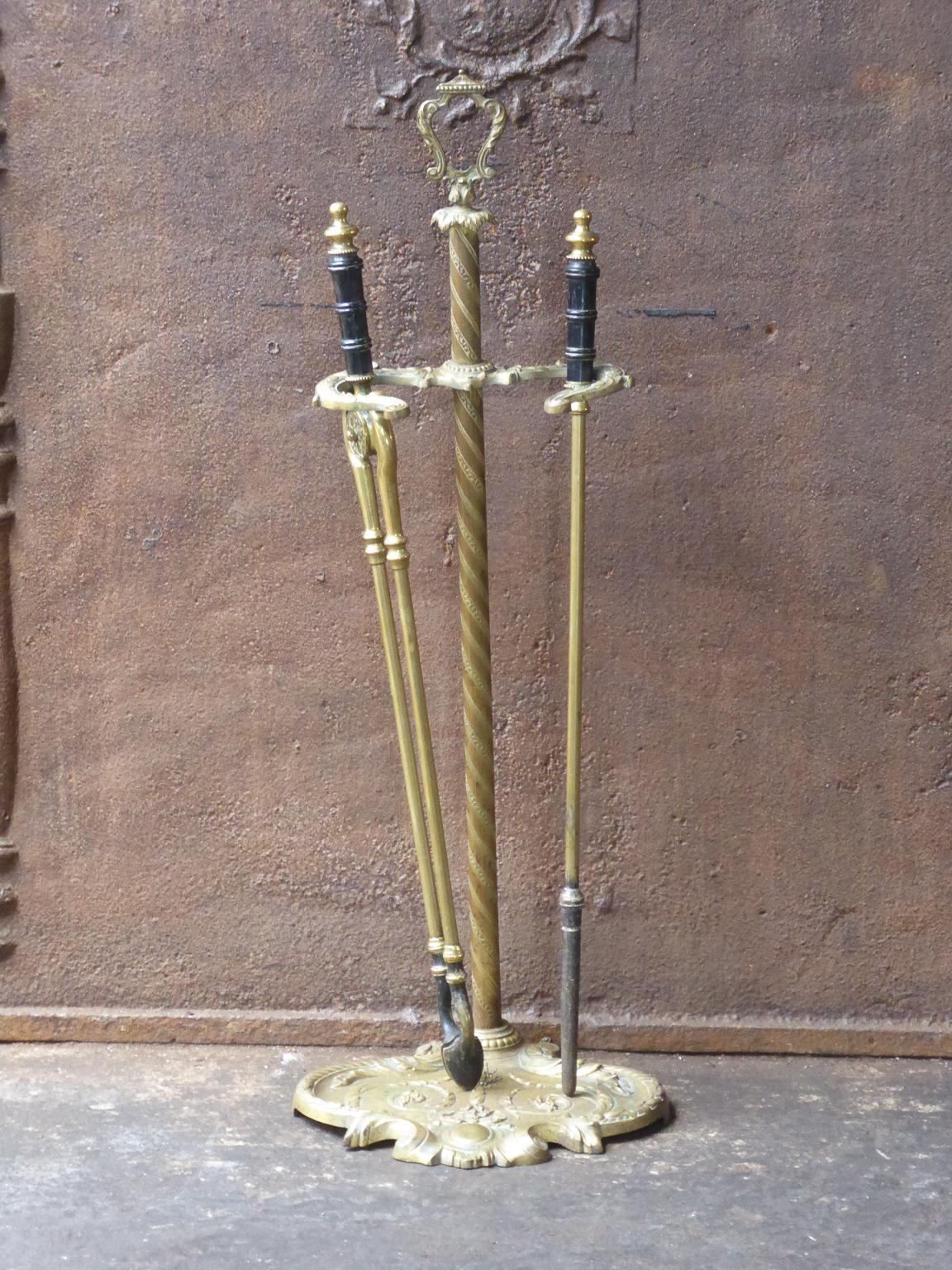 19th century English Victorian fire tool set. The set is made of wrought iron and brass. The set is in a good condition and is fully functional.