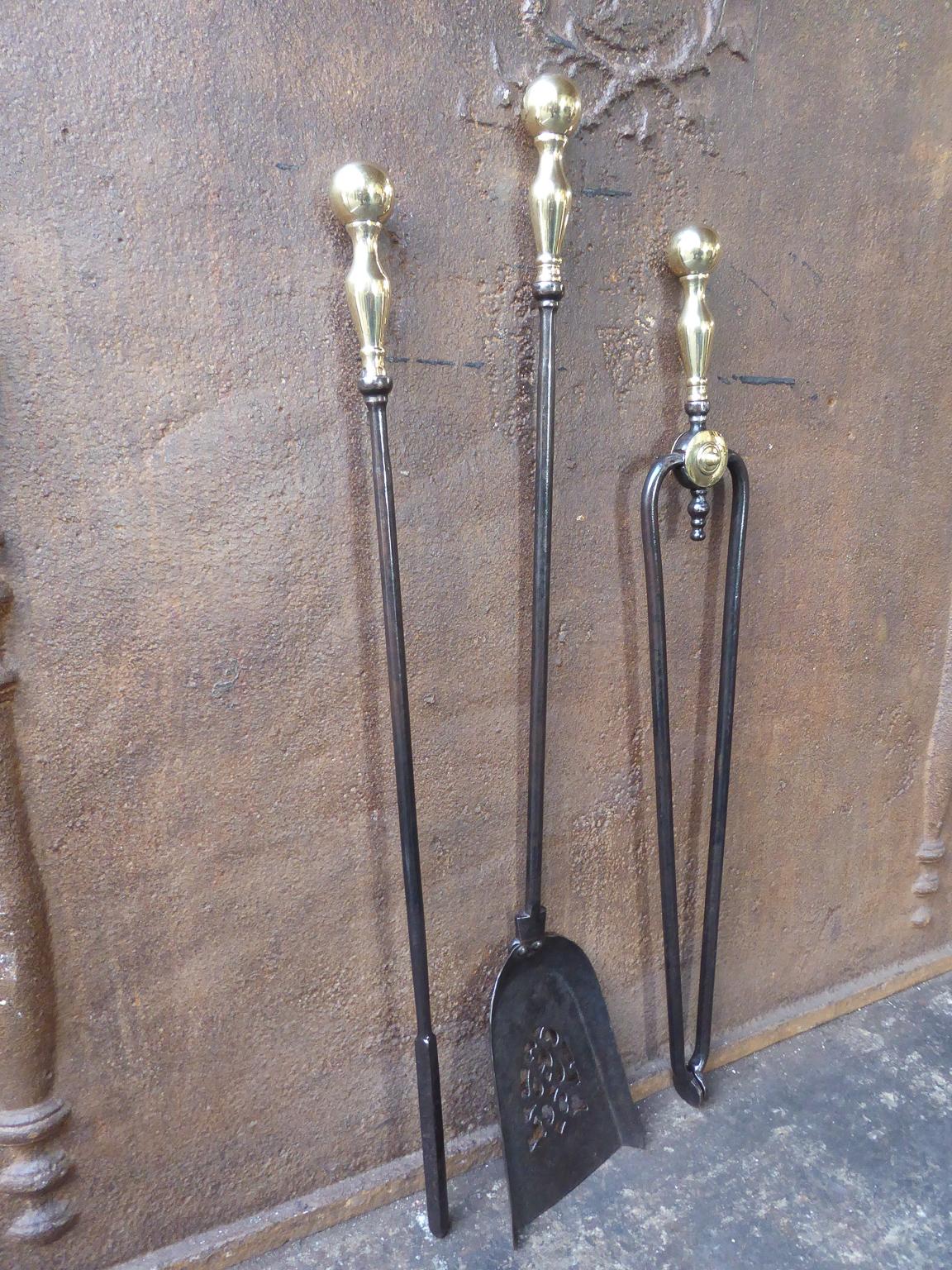 19th century English Victorian fire tool set. The set is made of wrought iron and polished brass. The set is in a good condition and is fully functional.

We have a unique and specialized collection of antique and used fireplace accessories