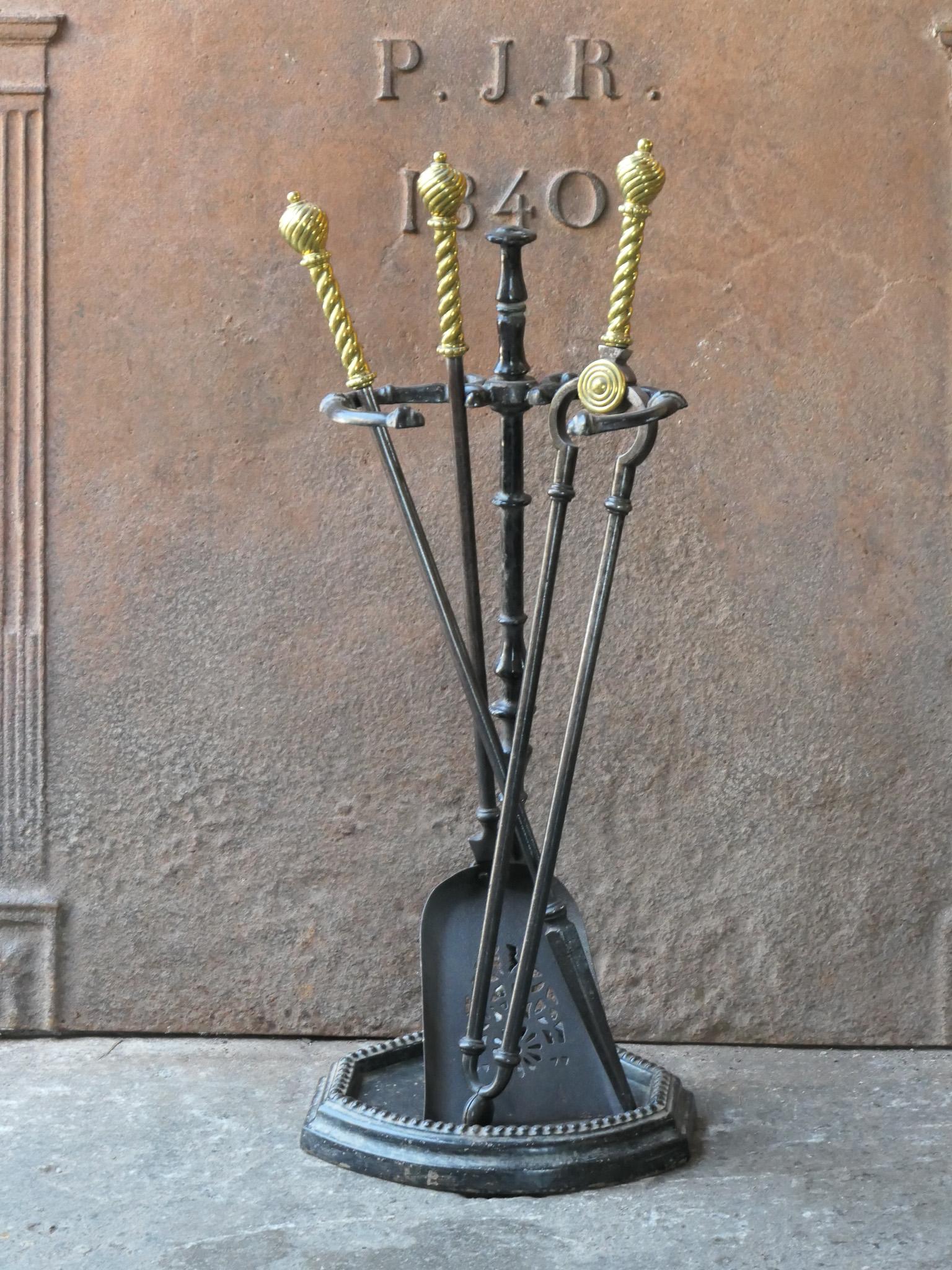 19th century English Victorian period fireplace toolset. The tools are made of wrought iron with brass handles, while the base is made of cast iron. The toolset consists of tongs, poker, shovel and stand. The condition is good.








.
