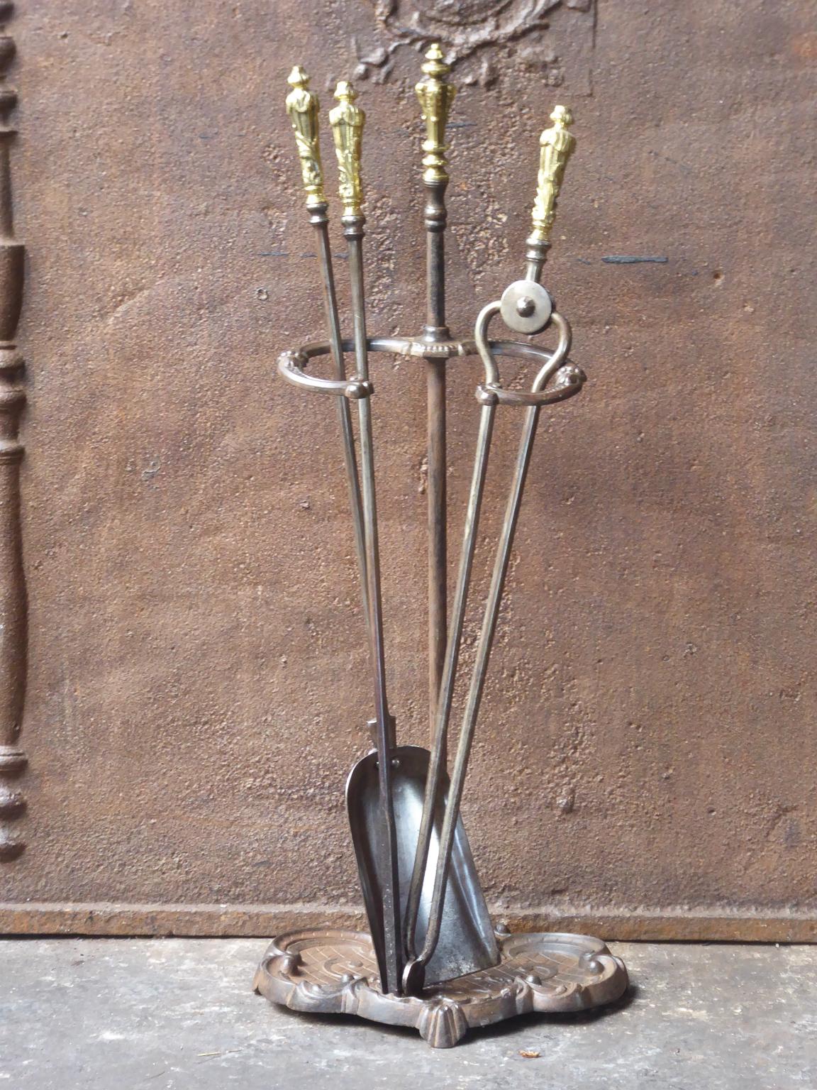 19th century English Victorian fireplace toolset made of cast iron, wrought iron and brass.













 