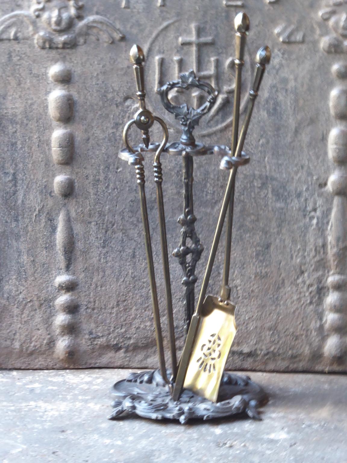 19th century English Victorian fireplace toolset made of cast iron and wrought iron. The toolset consists of three tools and a stand.













 