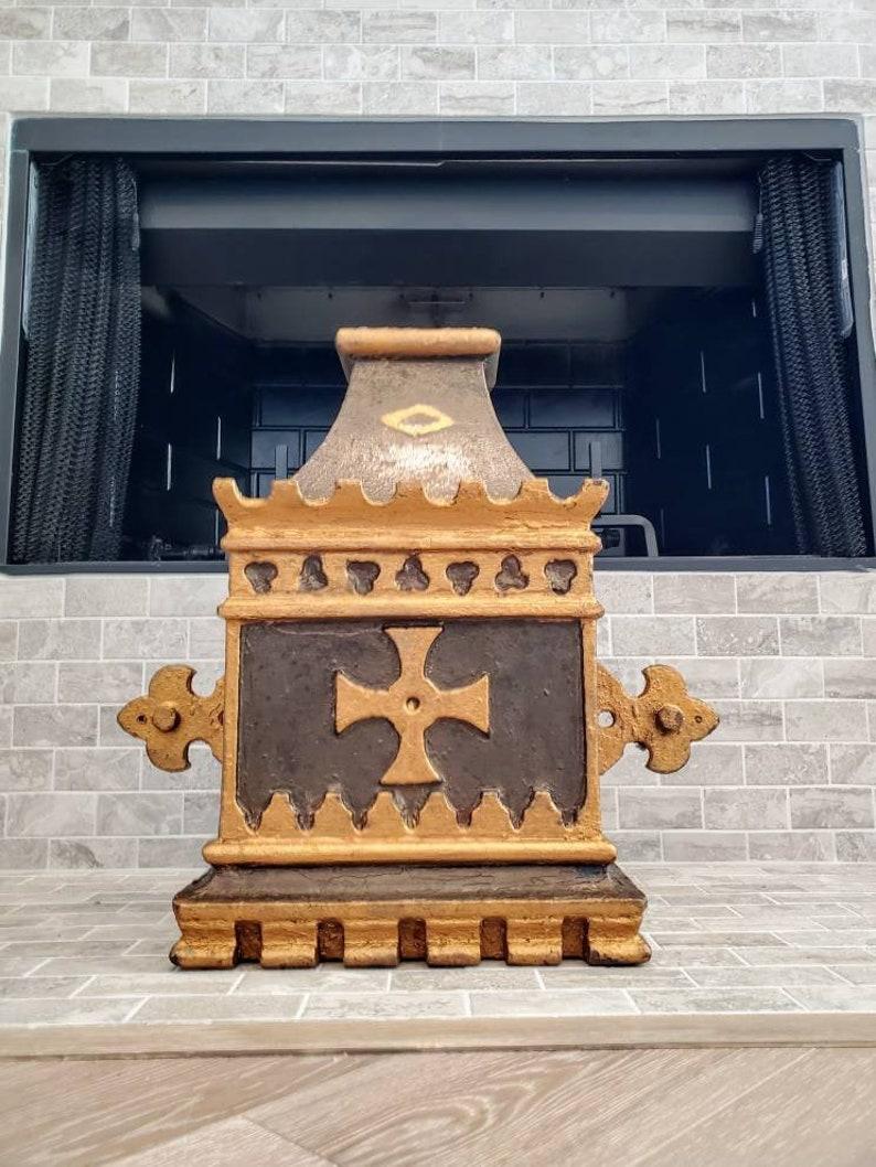 An impressive English Victorian Gothic Revival cast iron rainwater hopper, the architectural salvaged building element originating from a late 19th century church, decorated in hand painted, parcel gilt accented cross and trefoil motif.

This