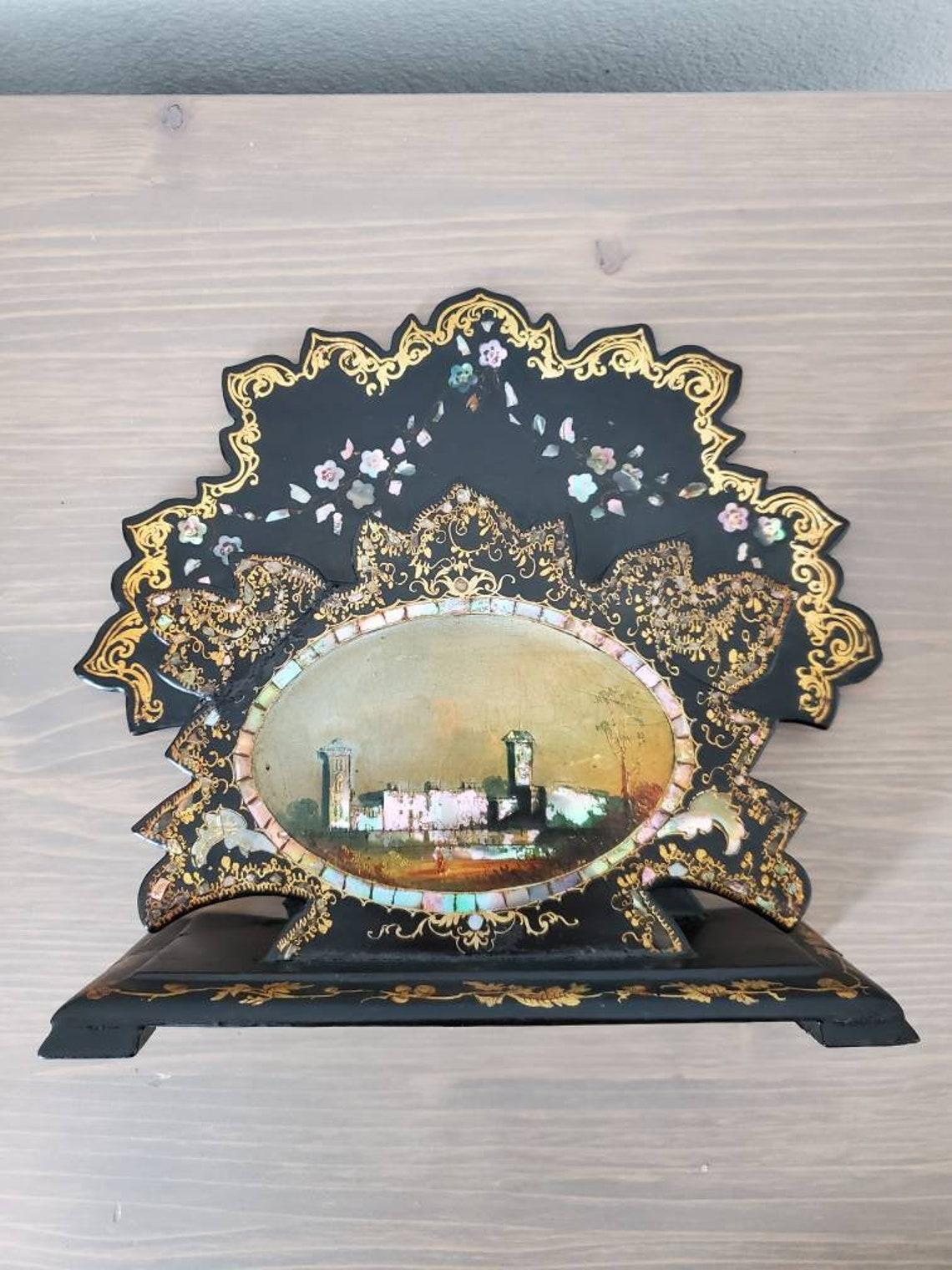 An English Victorian black and gilt decorated mother-of-pearl and papier mâché stationary letter / card holder or desk stand with stunning, exceptionally executed city scape hand painting portrait. 

Born in the mid 19th century, hand-crafted of