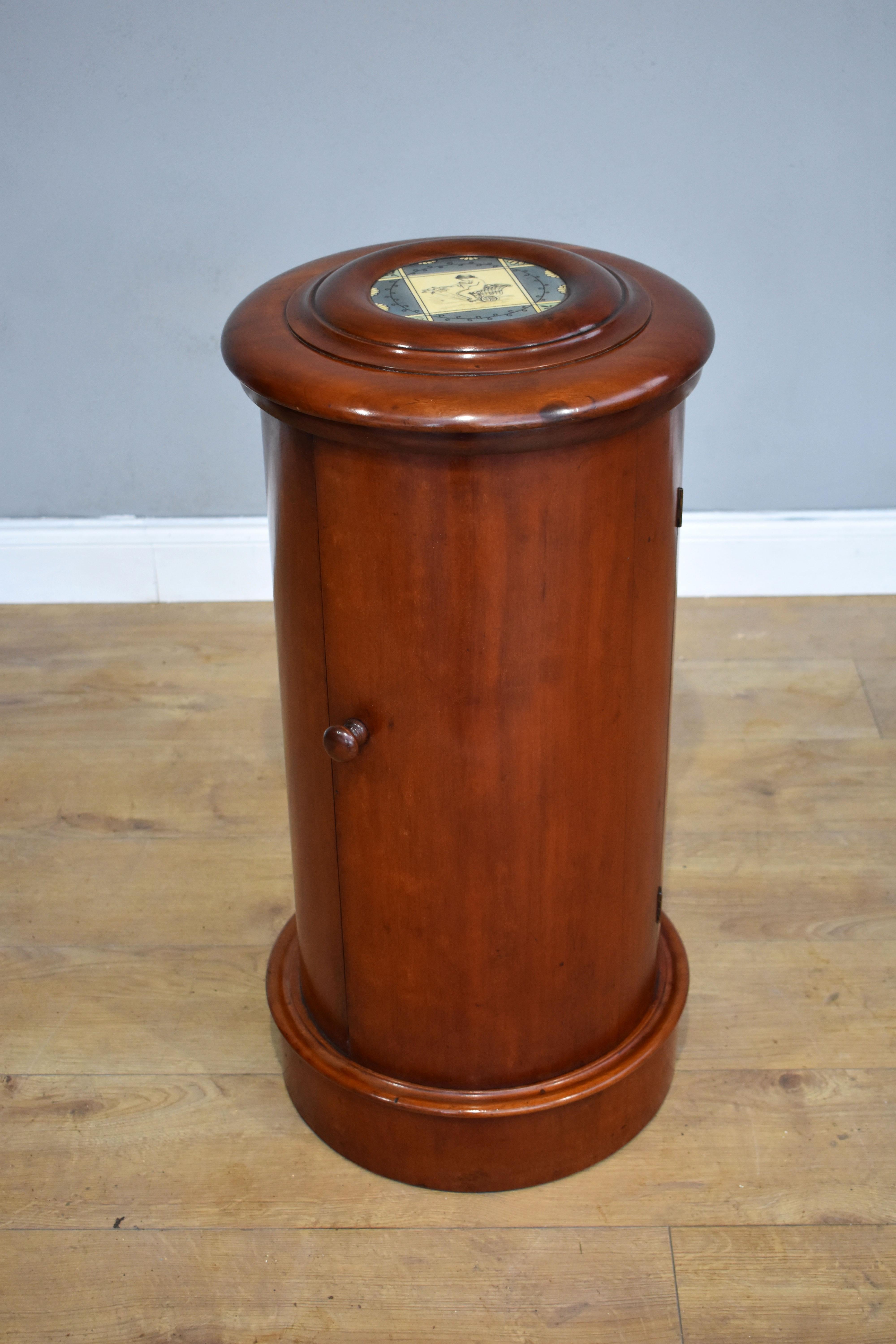 For sale is a good quality Victorian mahogany cylindrical pot cupboard, having a rising lid, featuring a painted porcelain plaque, raising to reveal a sink, which is a most unusual feature. Below this the cupboard door opens to a single shelf. The