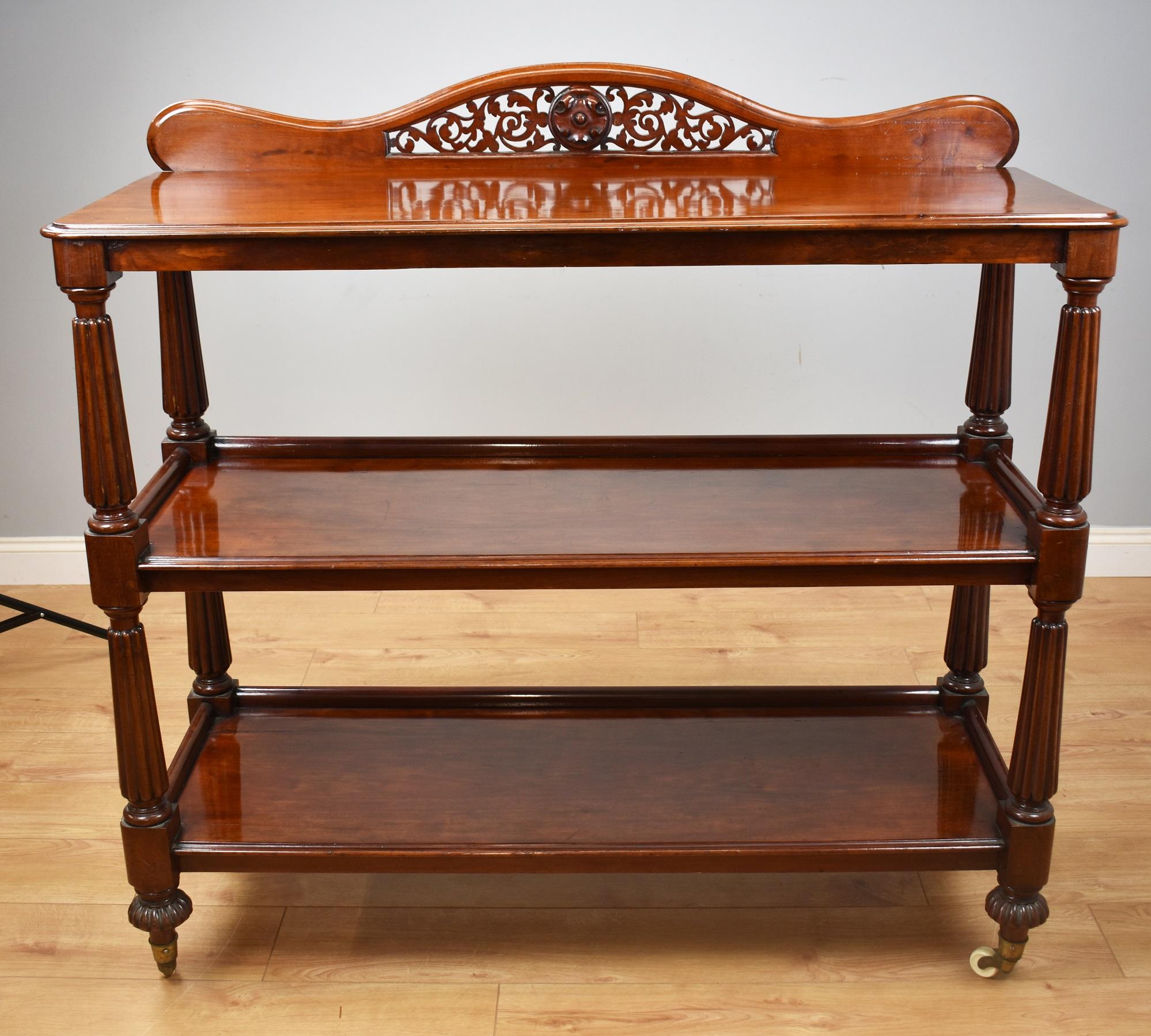 For sale is a good quality Victorian mahogany Dumbwaiter, having an arched and fretted gallery above three shelves, each supported by nice turned and reeded supports, terminating on gadrooned feet raised on original castors. This piece is in very