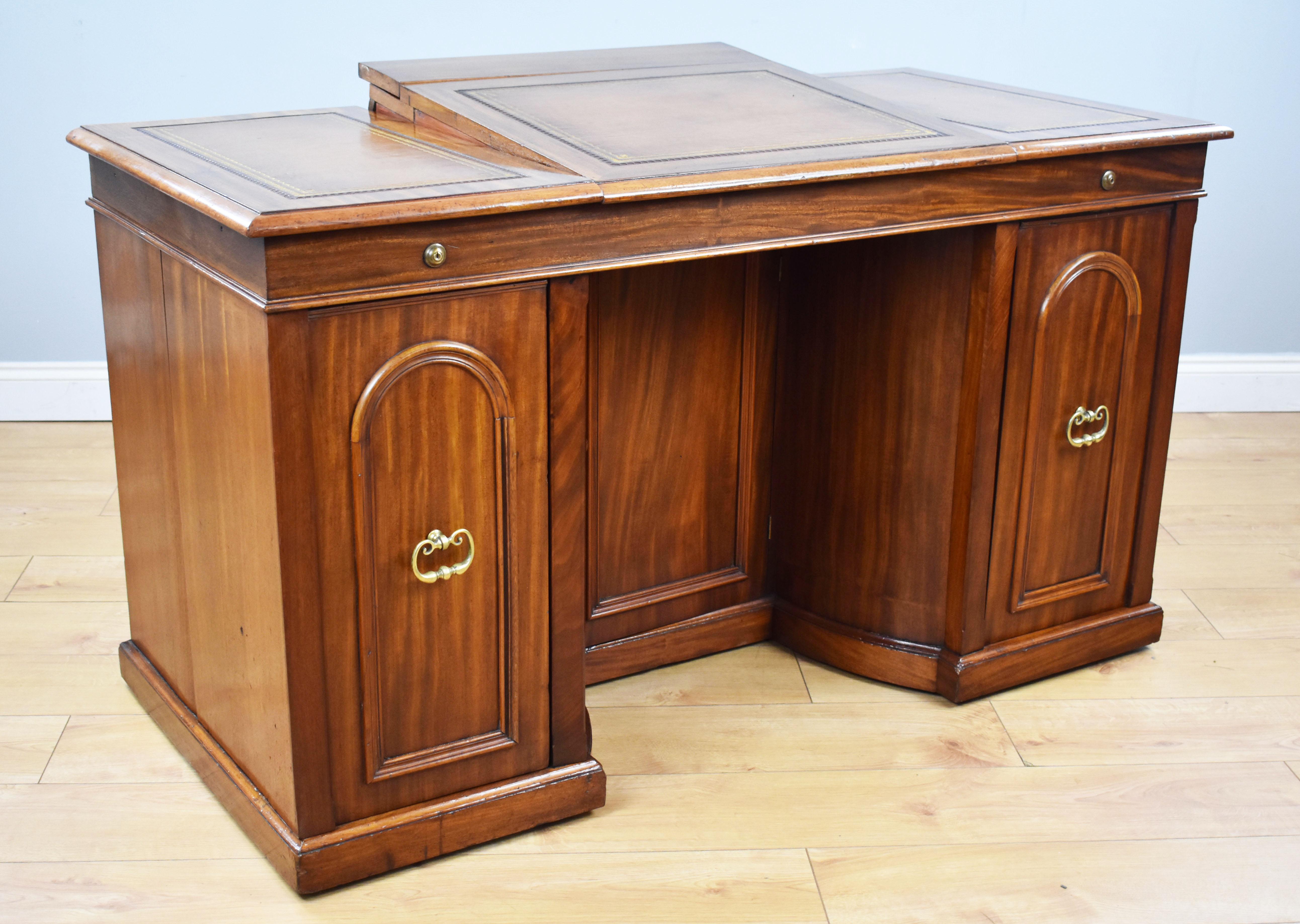 For sale is a good quality, unusual, Victorian mahogany kneehole desk by Francis and James Smith, Glasgow. The top, having three leather writing surfaces, each decorated with gold and blind tooling. Below this, there are two arched panels, each