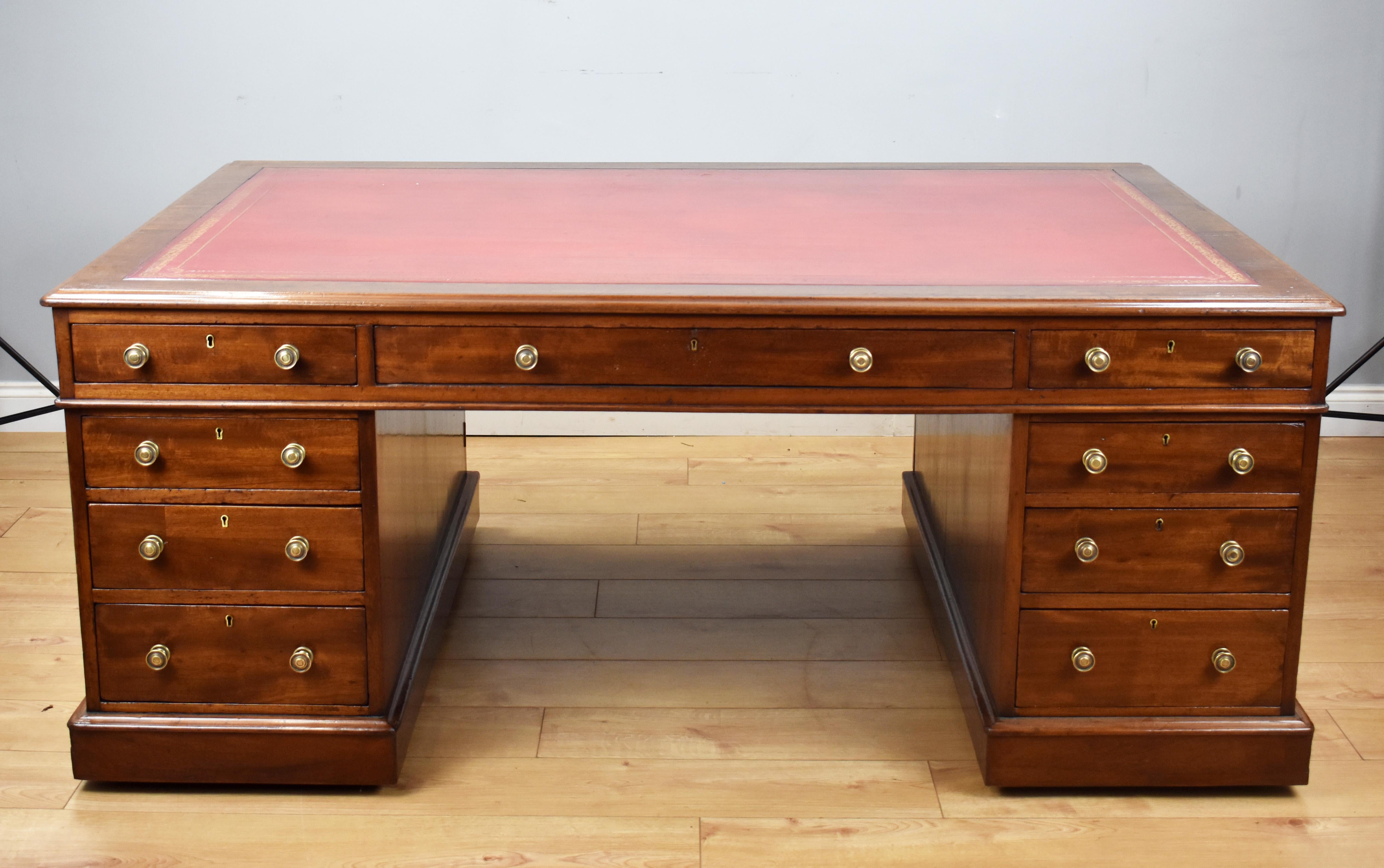 For sale is a good quality Victorian mahogany partners desk by Davis & Co, Tottenham Court Road, London. Of large proportions, the desk has a read leather hide writing surface, decorated with gold tooling, above three drawers in the top the front,