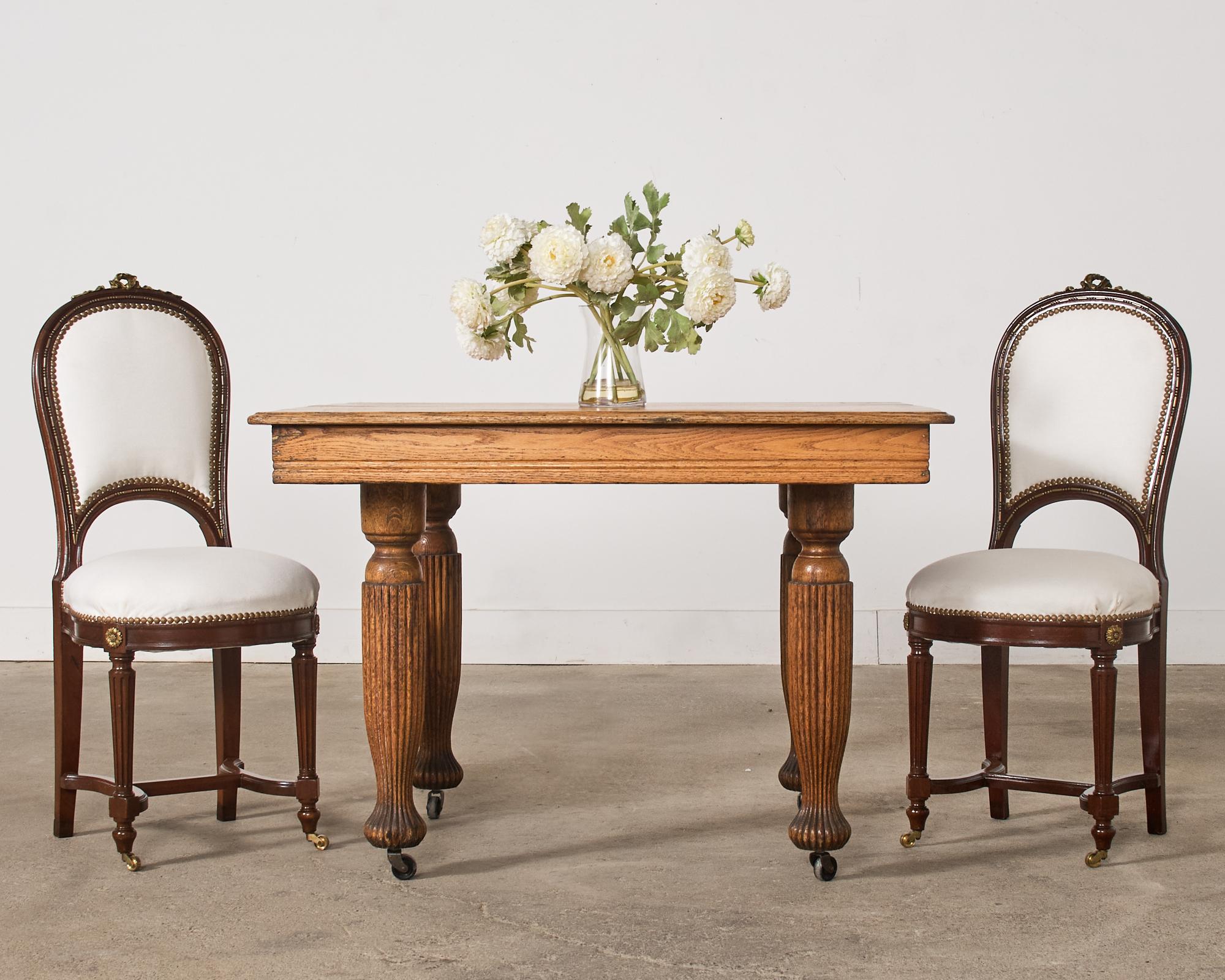 Handsome 19th century English victorian square dining table or center table crafted from oak. This extending dining table does not have any leaves available and was used as a display piece by artist Ira Yeager (American 1938-2022) in his Calistoga,