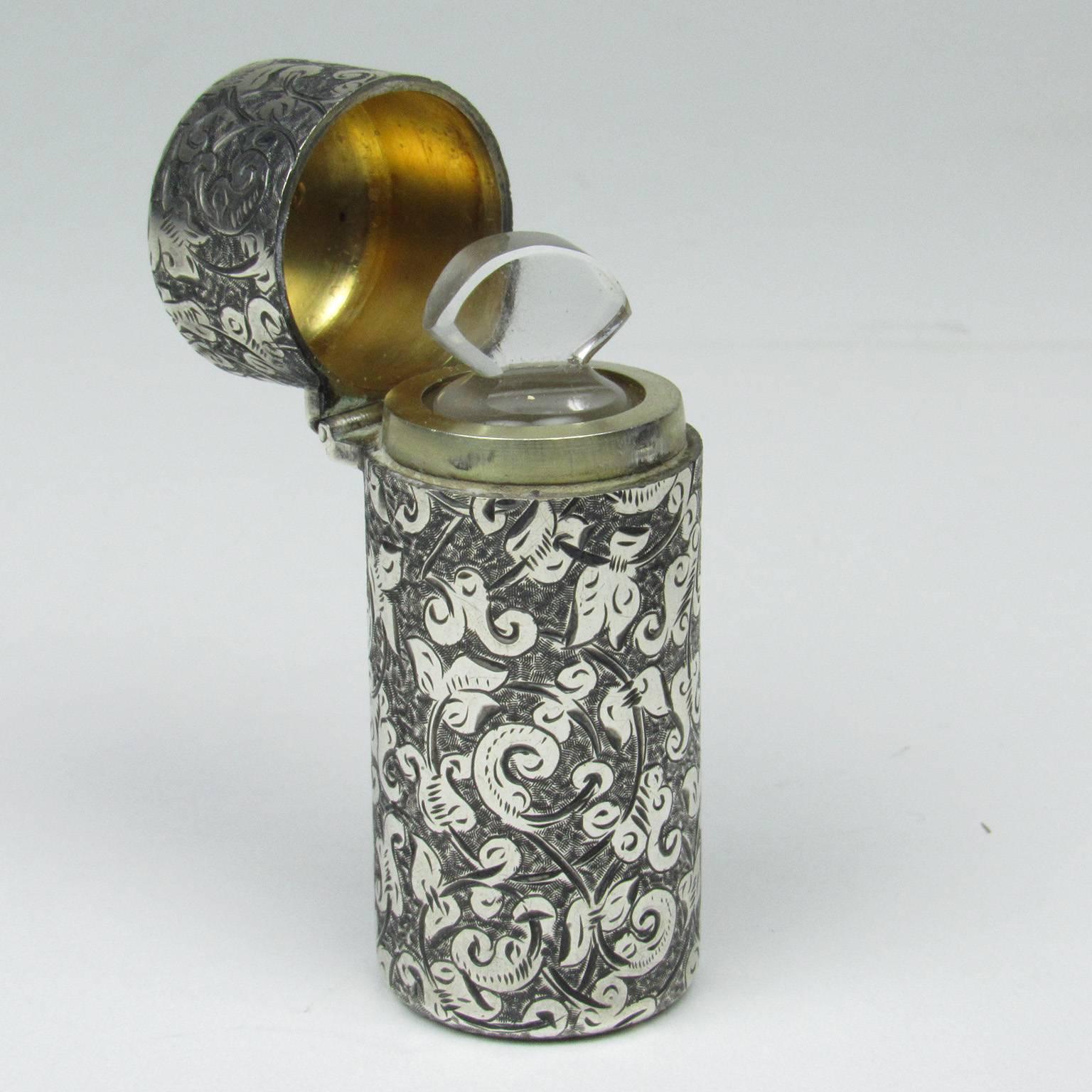 English Victorian sterling silver perfume with floral decoration with flip top revealing a gilt interior with glass insert and cut-glass stopper. Bears maker's mark for Sampson Mordan and hallmarks for London, 1883; with Victoria assay mark.