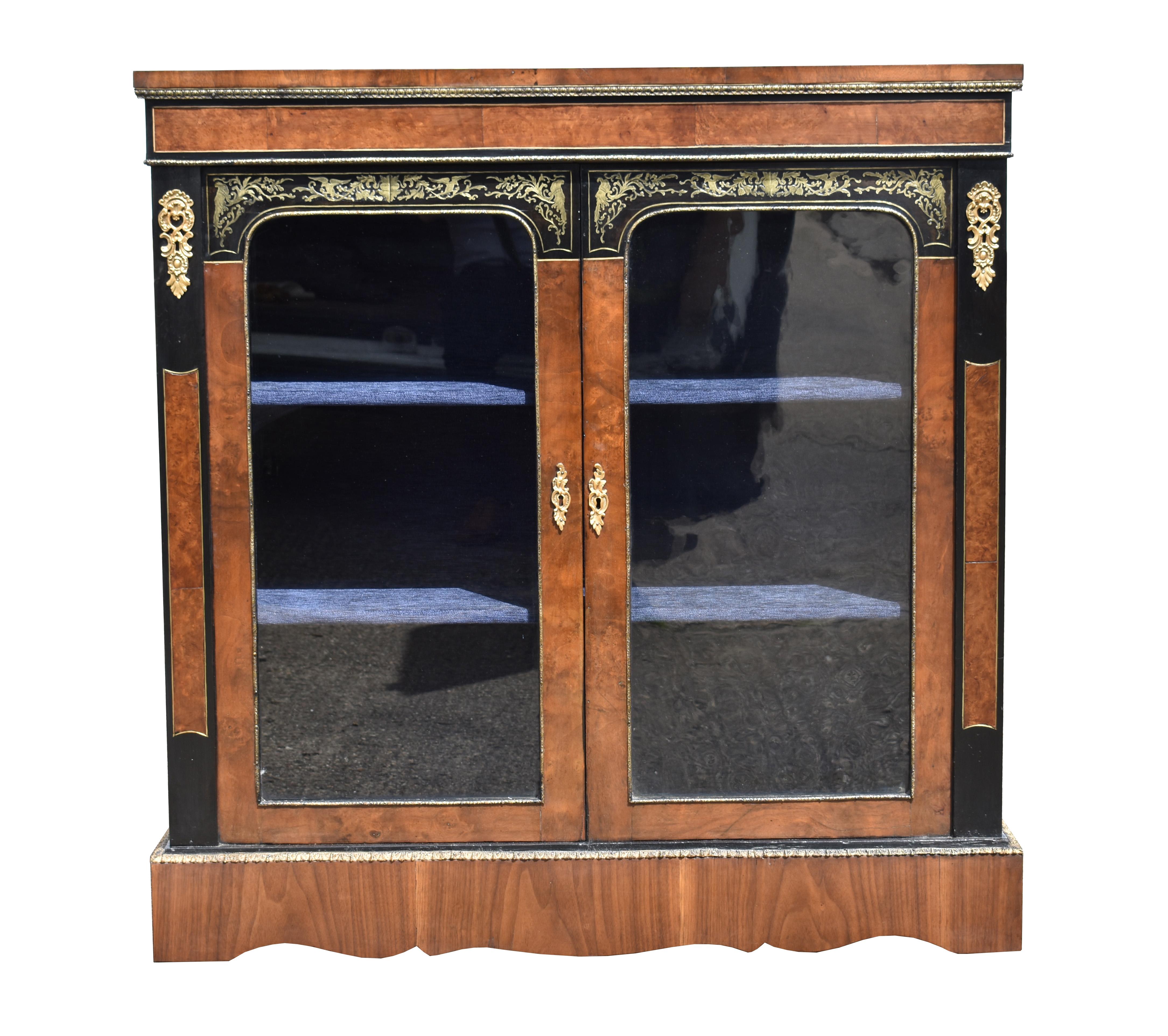 For sale is a good quality Victorian walnut and ebonized pier cabinet, having two brass inlaid doors above a shaped plinth. This piece remains in good overall condition, showing minor signs of wear commensurate with age and use. 

Measures: Width