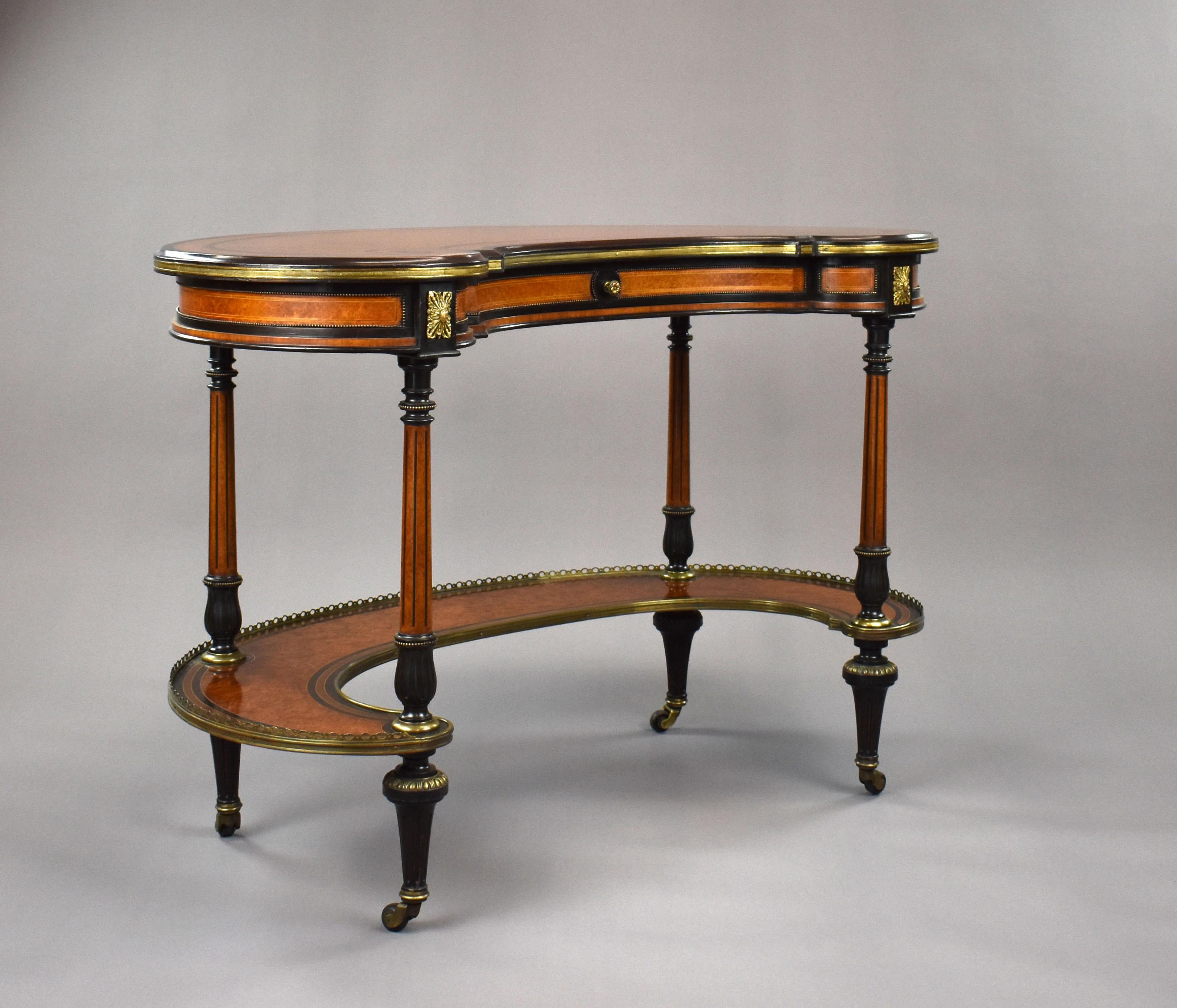 For sale is a top quality mid Victorian amboyna, burr walnut and ebonised kidney shaped writing table by Gillows of Lancaster. The top is nicely inlaid with ebony and white line stringing, above a single drawer to the front with a single brass