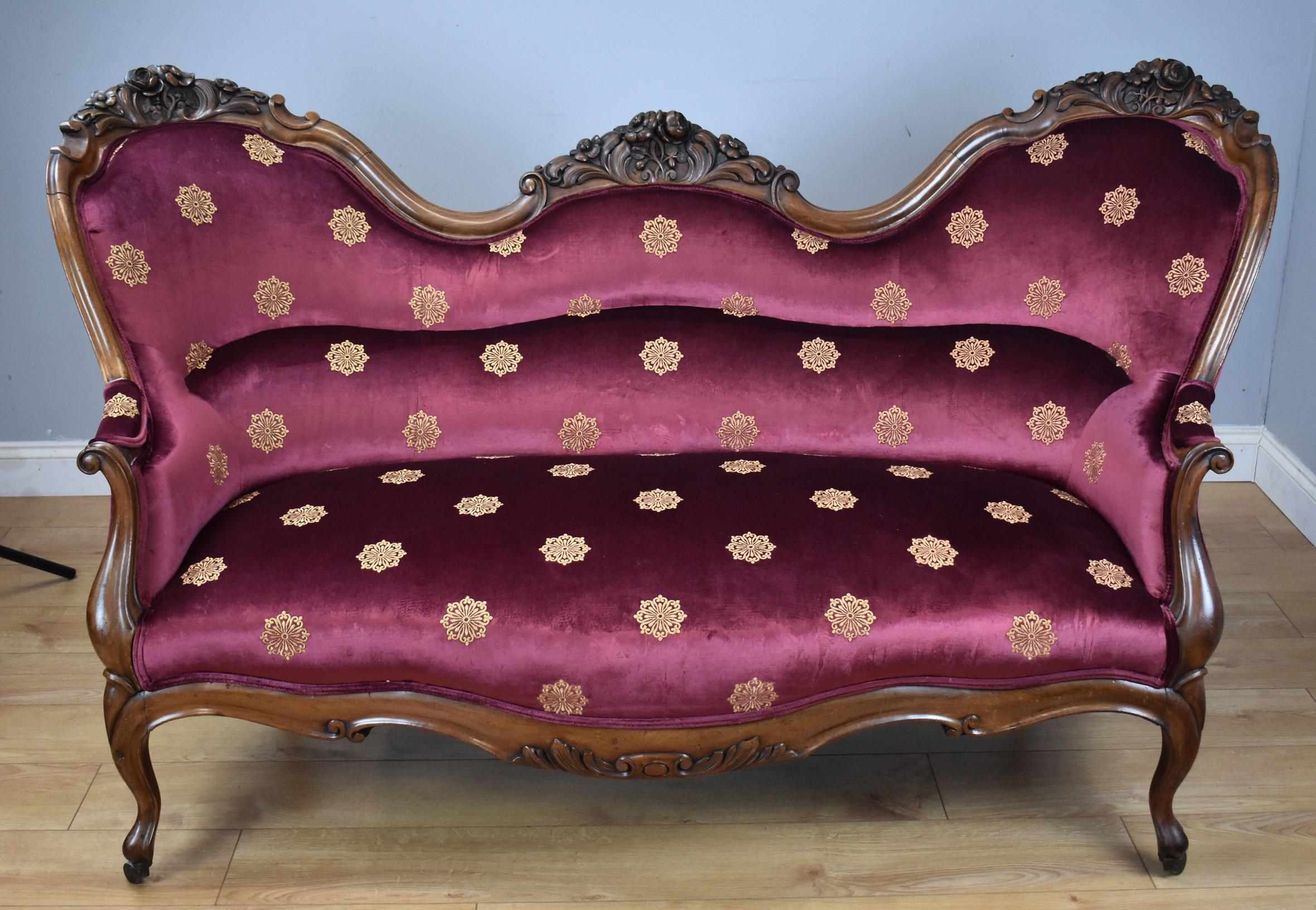 For sale is a good quality Victorian walnut framed settee. Having an ornately carved and shaped frame, standing on elegant legs raised on original brass castors, this piece remains structurally sound and is in very good condition for its age. All of