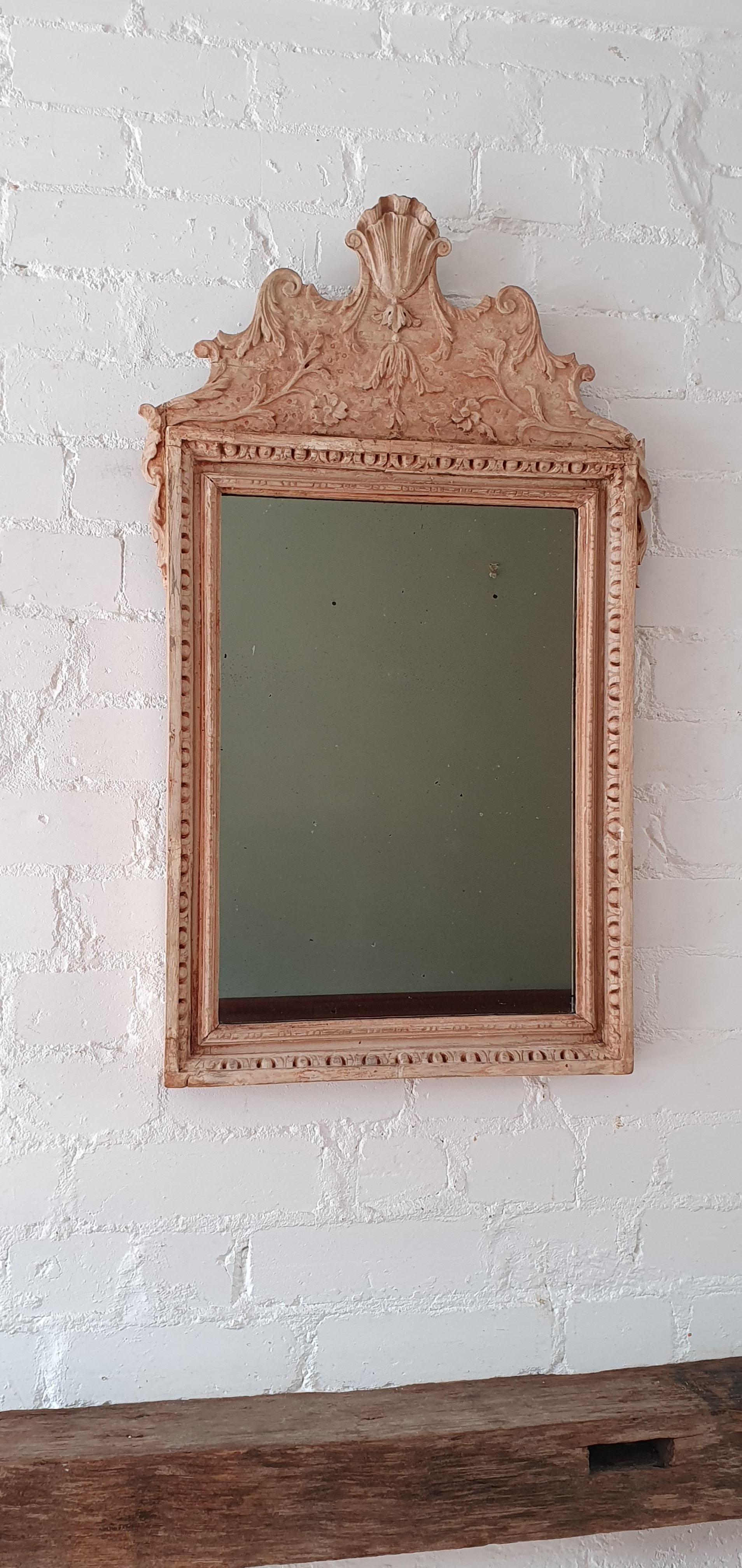 19th century provincial English wall mirror, Heavily distressed carved wood frame covered with remains of gesso,(gilding gone).
Original mercury glass with sign of age (scratches, black spots, etc). Unusual small mirror made by provincial maker