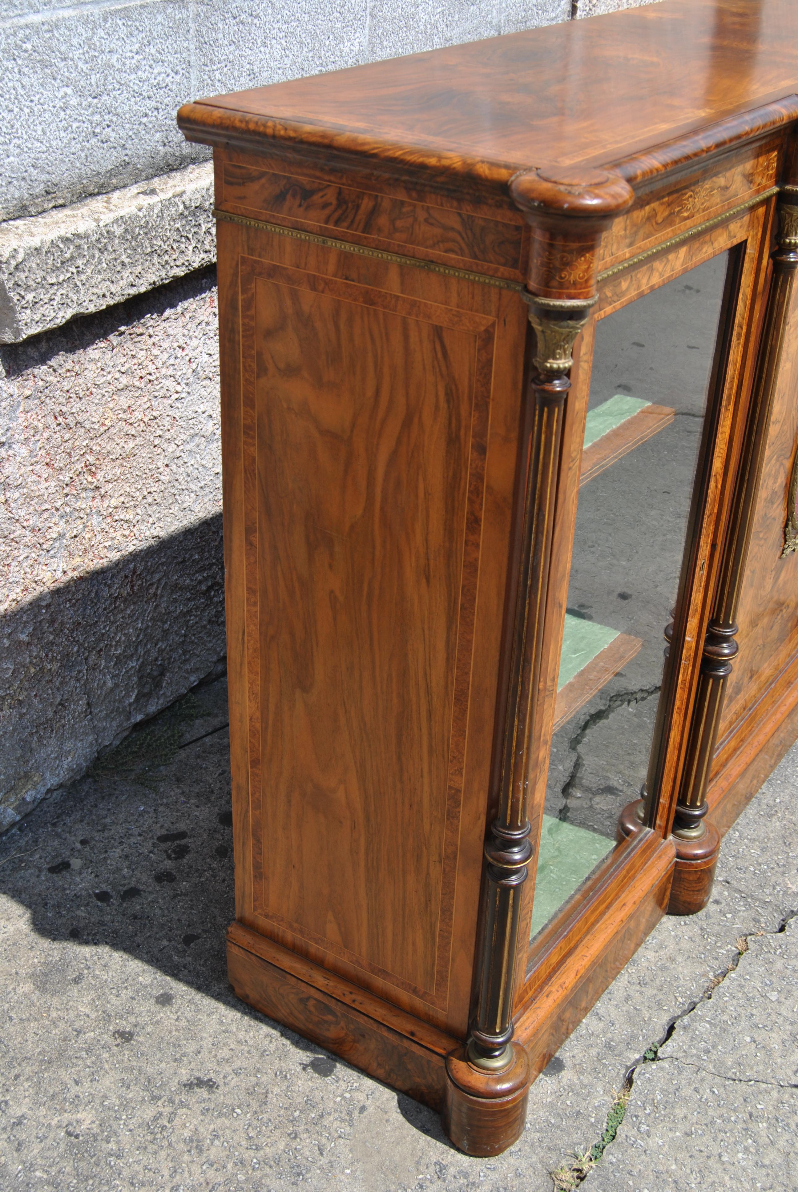 This is a walnut credenza / server / display cabinet made in England, circa 1860. The entirety of the piece is done in walnut and an incredible, highly figured cut of Kashmir walnut (Kashmir walnut is the finest cut of burr walnut). The cabinet has