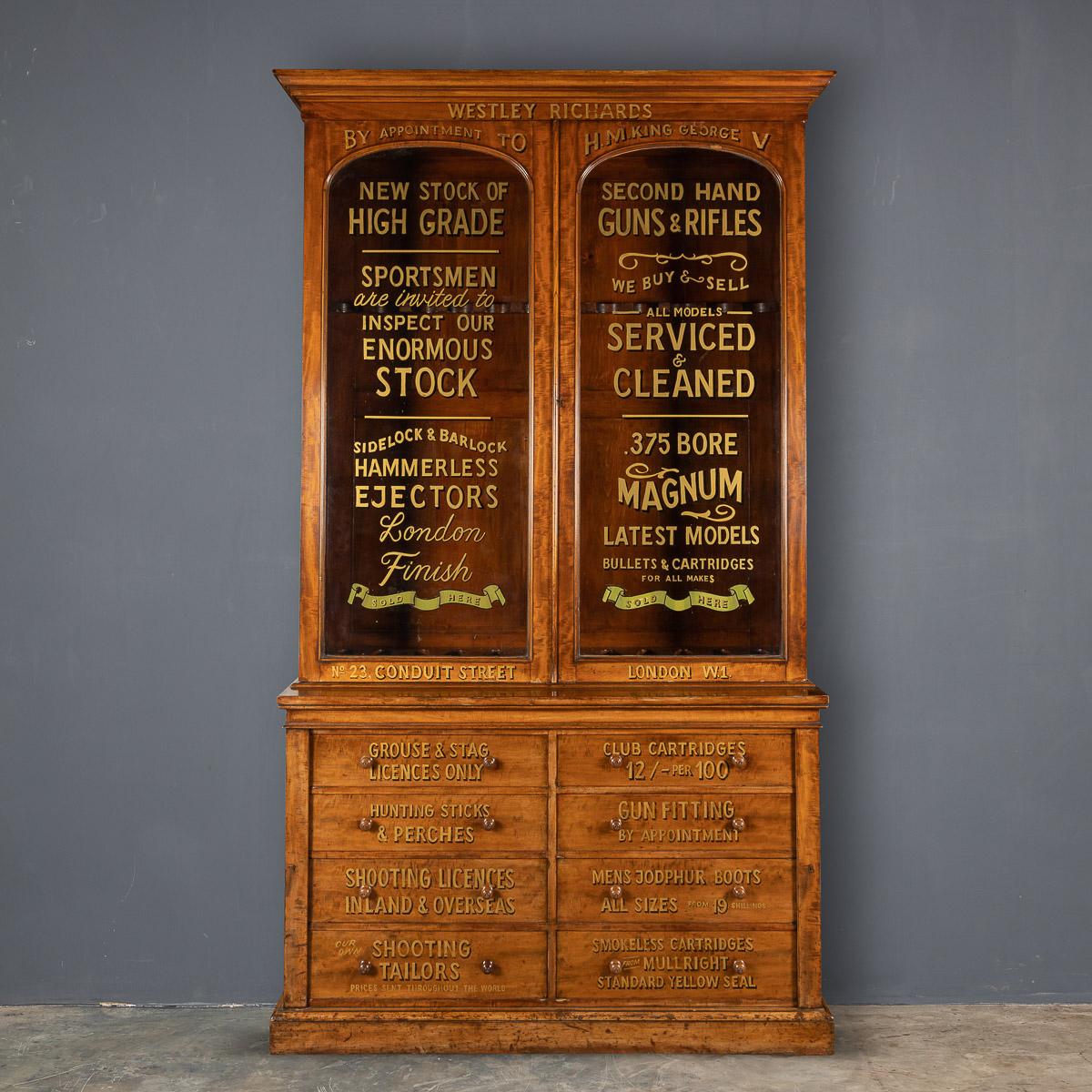 Antique 19th century English walnut gun cabinets, with working locks and keys. Beautiful pieces of period furniture, later painted with various shooting related advertising and compartments for various cartridges and shooting accessories, a very