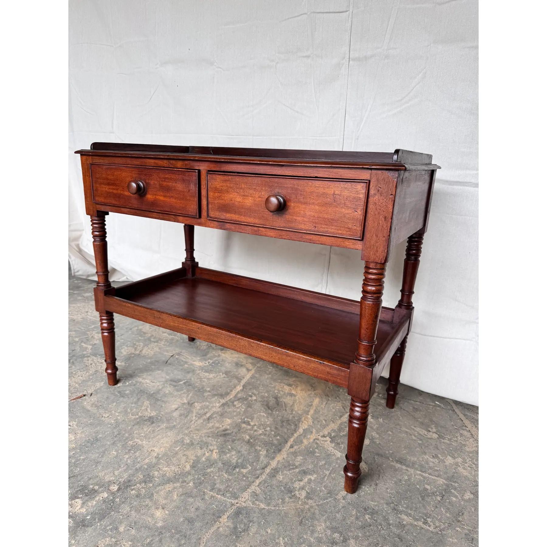 This is a very nice English wash stand from the 19th century two drawers nicely turned legs, a second shelf, beautiful patina wears it's at age beautifully. Recently polished with two drawers that sliding effortlessly for the age you can consider