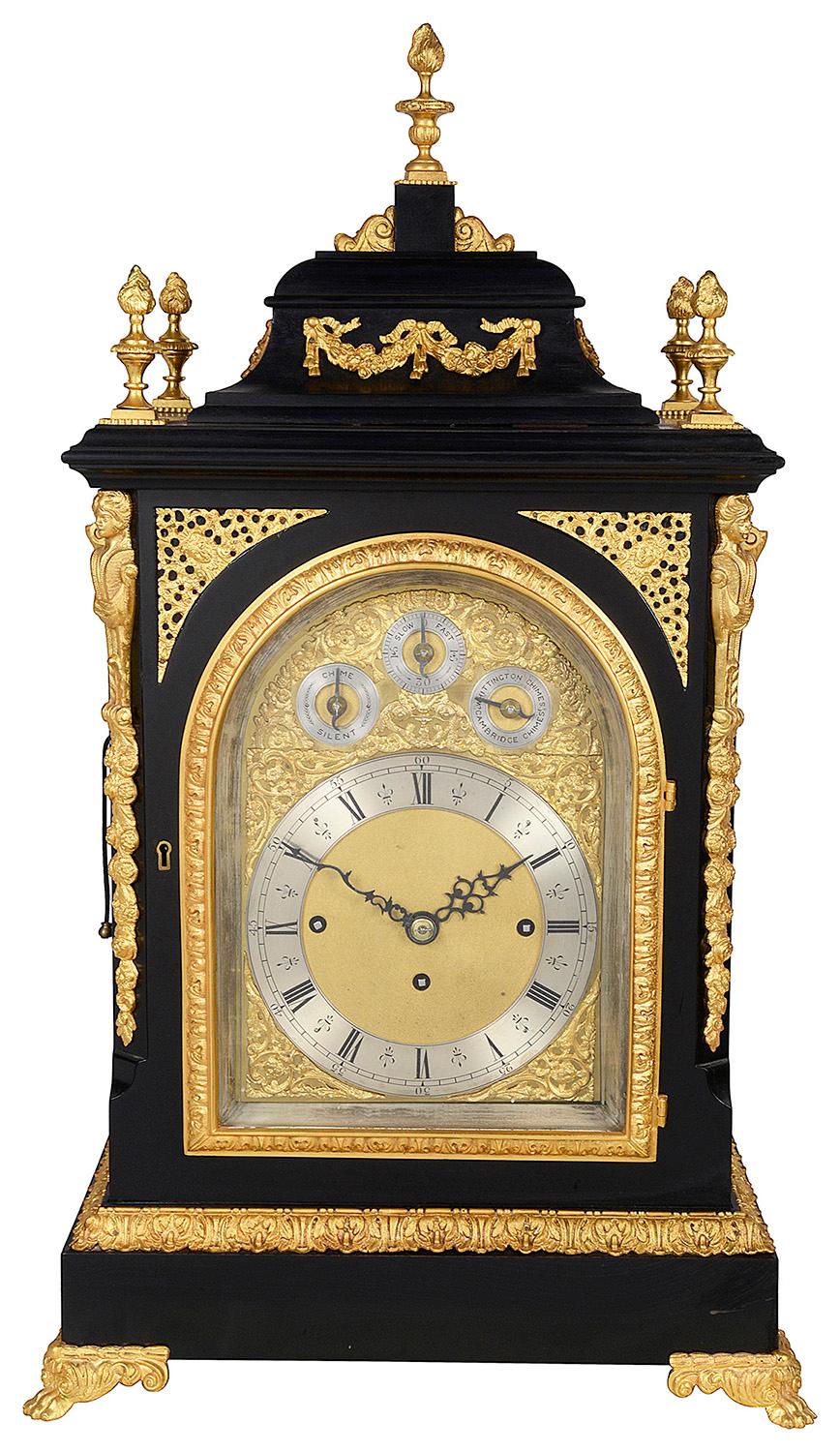 A very impressive 19th century English ebonized and gilded ormolu mantel clock, having a three train movement, an eight day duration, striking on the hour and half hour on bells and gong.
It chimes the Westminster and Whittington, with a silent