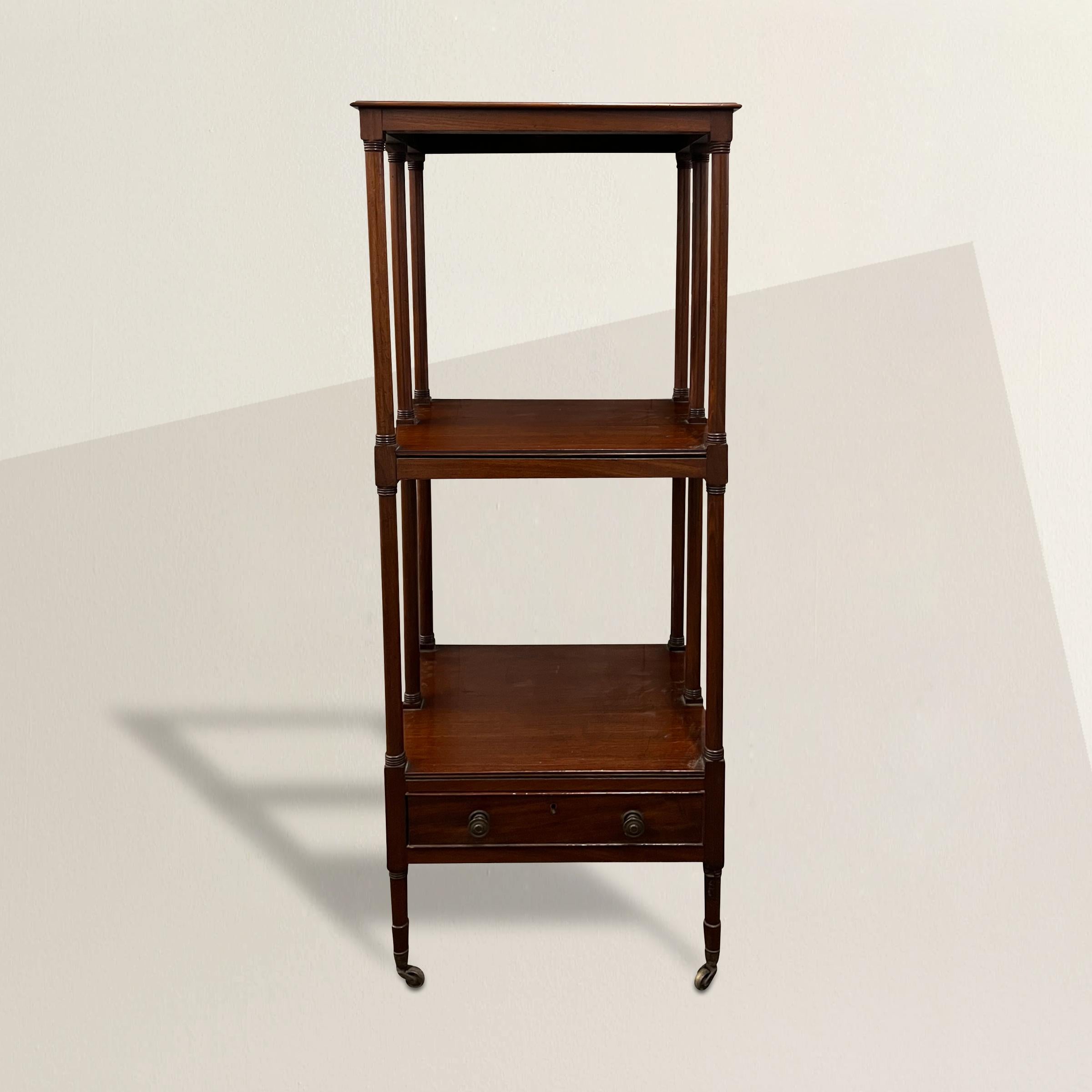 A fantastic late 19th century English mahogany whatnot, or tired stand, with beautifully turned supports mimicking columns, two shelves, and a lower drawer with two brass knobs. Whatnots were originally used to display Victorian curios, or whatnots,