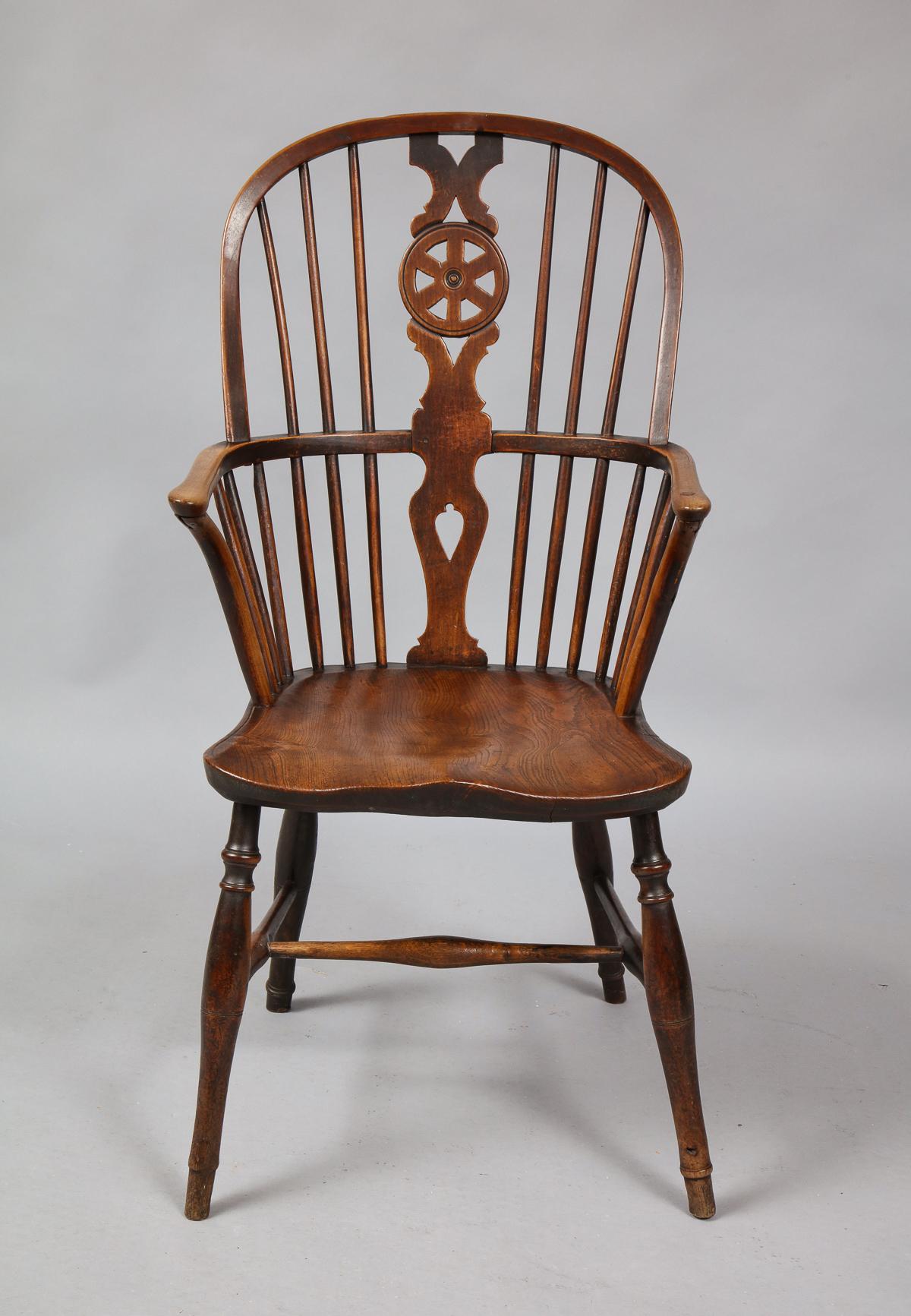 A good mid-19th century English hoop back Windsor armchair having pierced wheel splat over shaped elm seat and well turned legs joined by 