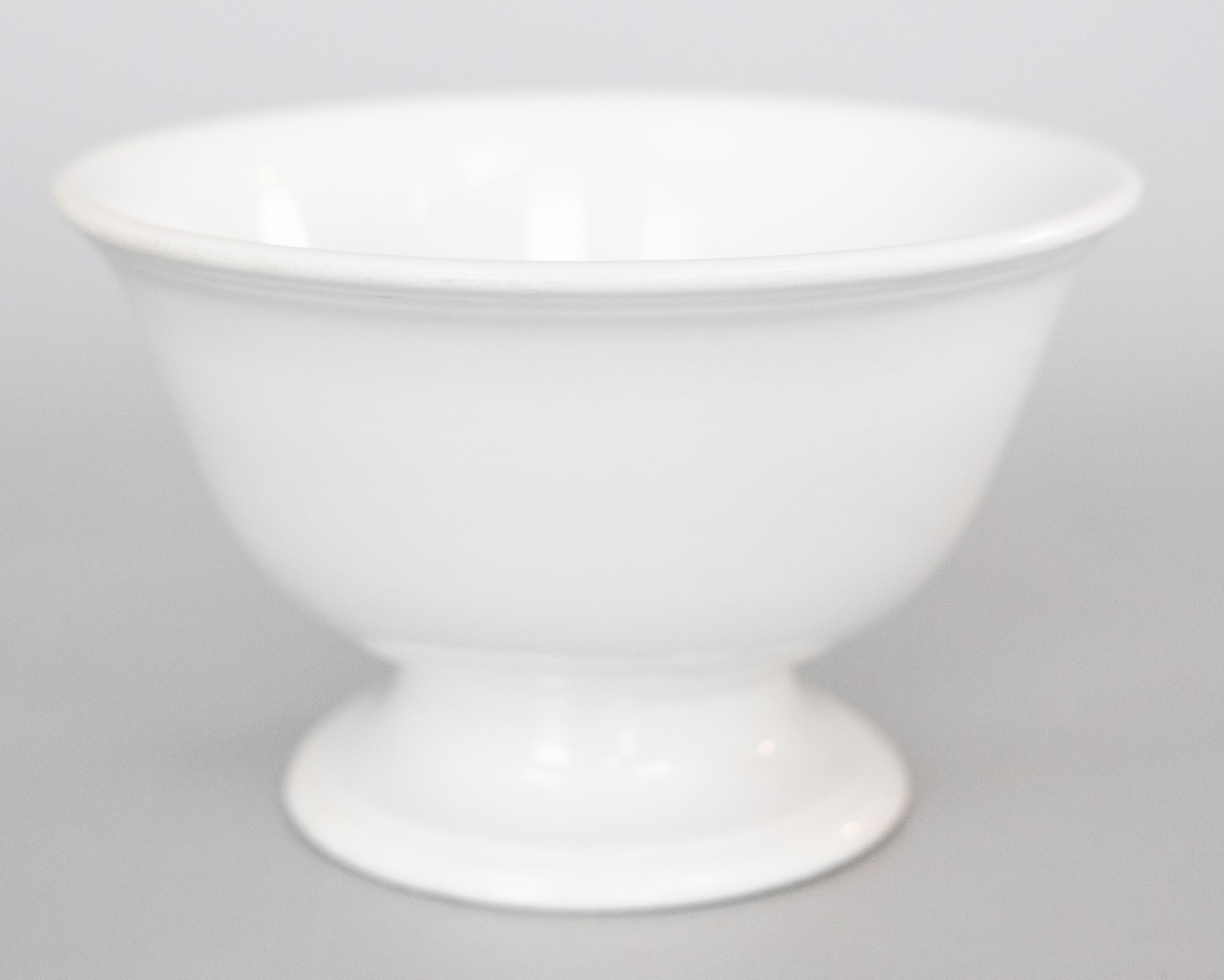 A lovely antique 19th-Century English Staffordshire white ironstone pedestal punch bowl by Johnson Brothers, Hanley, Stoke-on-Trent, England, circa 1880. Maker's mark on reverse. A highly collectible ironstone piece in beautiful antique condition.