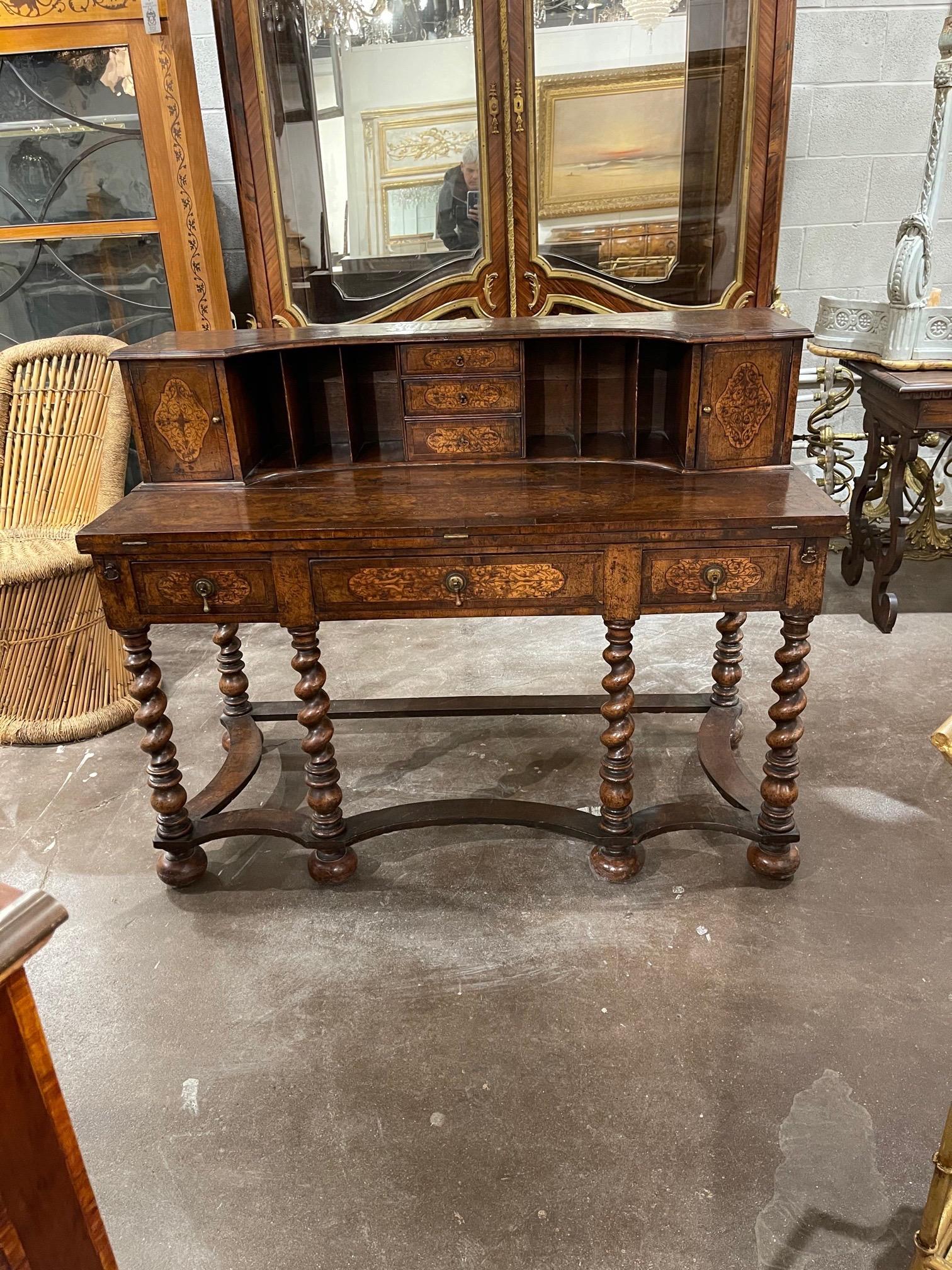 Handsome 19th century English William and Mary carved inlaid walnut desk. Pretty floral images and lots of areas for storage. A splendid piece!