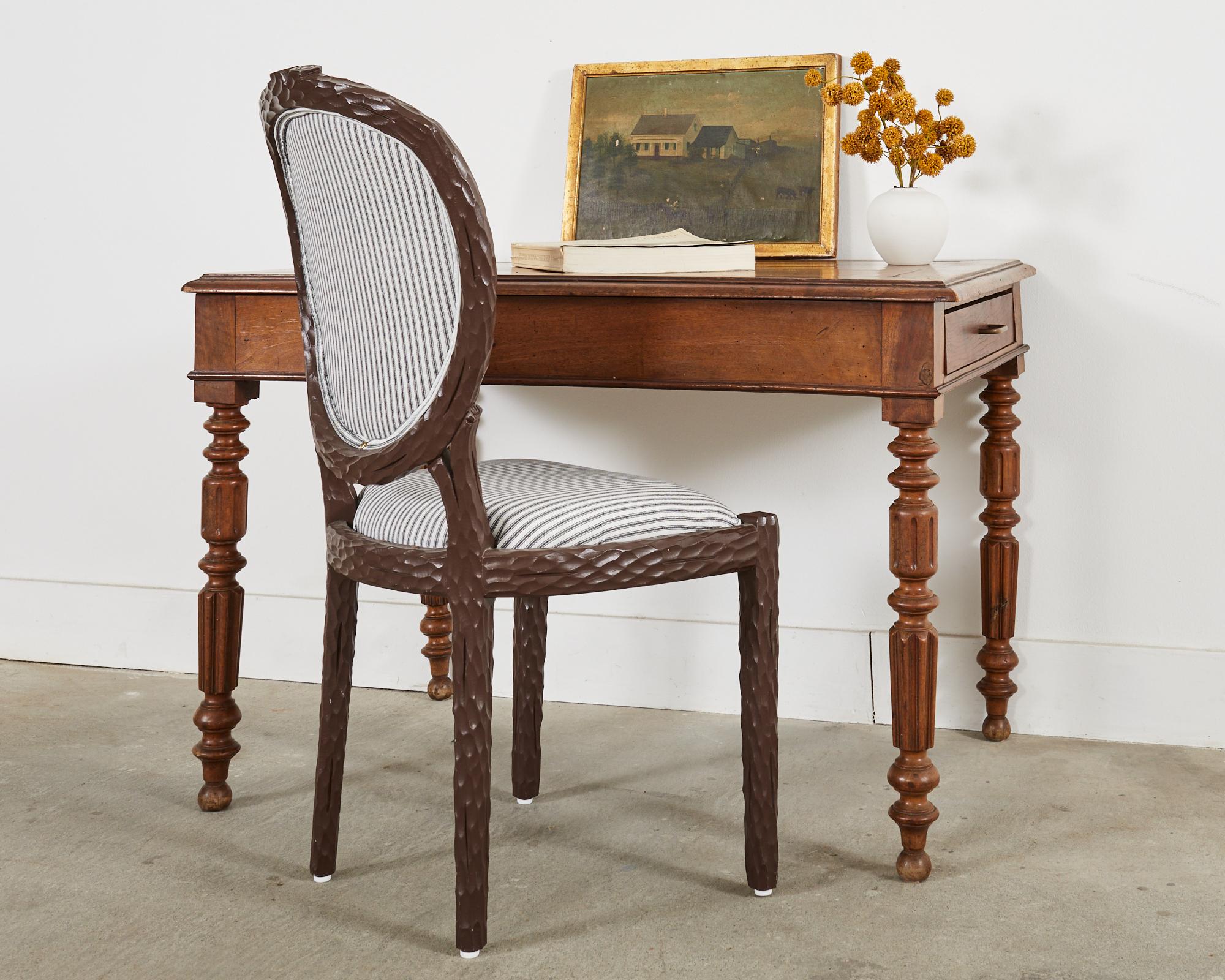 Handsome 19th century English William IV writing table or desk crafted from mixed fruitwood and oak. The table has storage drawers on each end with patinated brass pulls. The top has a decorative ogee edge on the border. The desk features whimsical