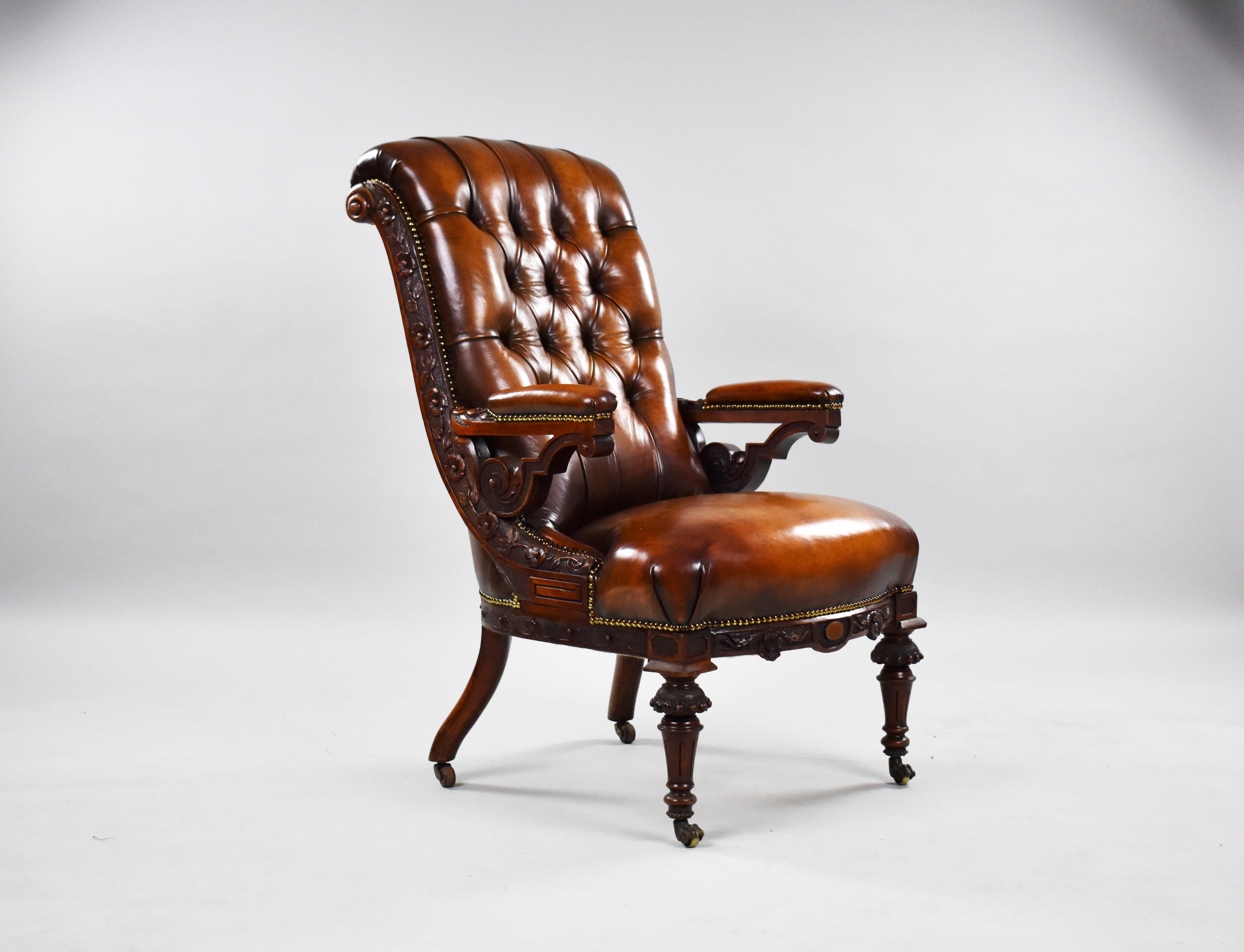 For sale is a fine quality William IV mahogany armchair. Upholstered in hand dyed leather, having a deep buttoned back, in an ornate foliate carved show frame raised on fluted legs with highly unusual brass paw castors. The chair is in very good