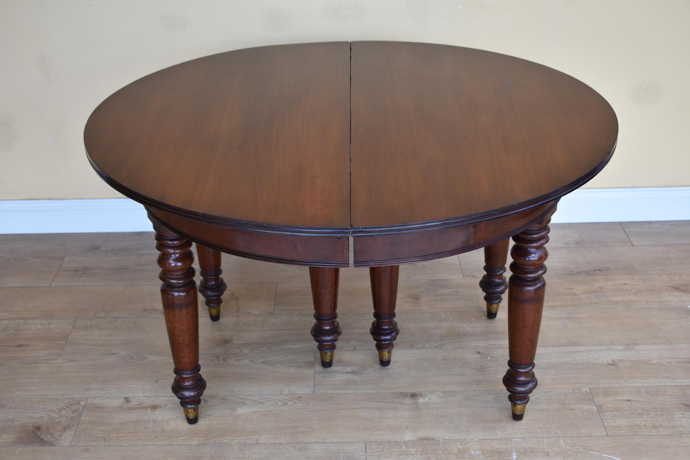 For sale is a good quality William IV oval dining table with a single additional leaf. Each end standing on three turned legs terminating on brass caps, the table has an additional leaf held in place with an unusual brass locking system. Overall,