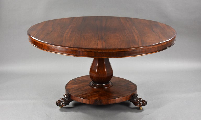 For sale is a good quality William IV rosewood circular breakfast table, having a tilt top, above a platform base raised on carved lions paw feet. The table is in very good condition for its age, showing some evidence of a heat mark to the top (see