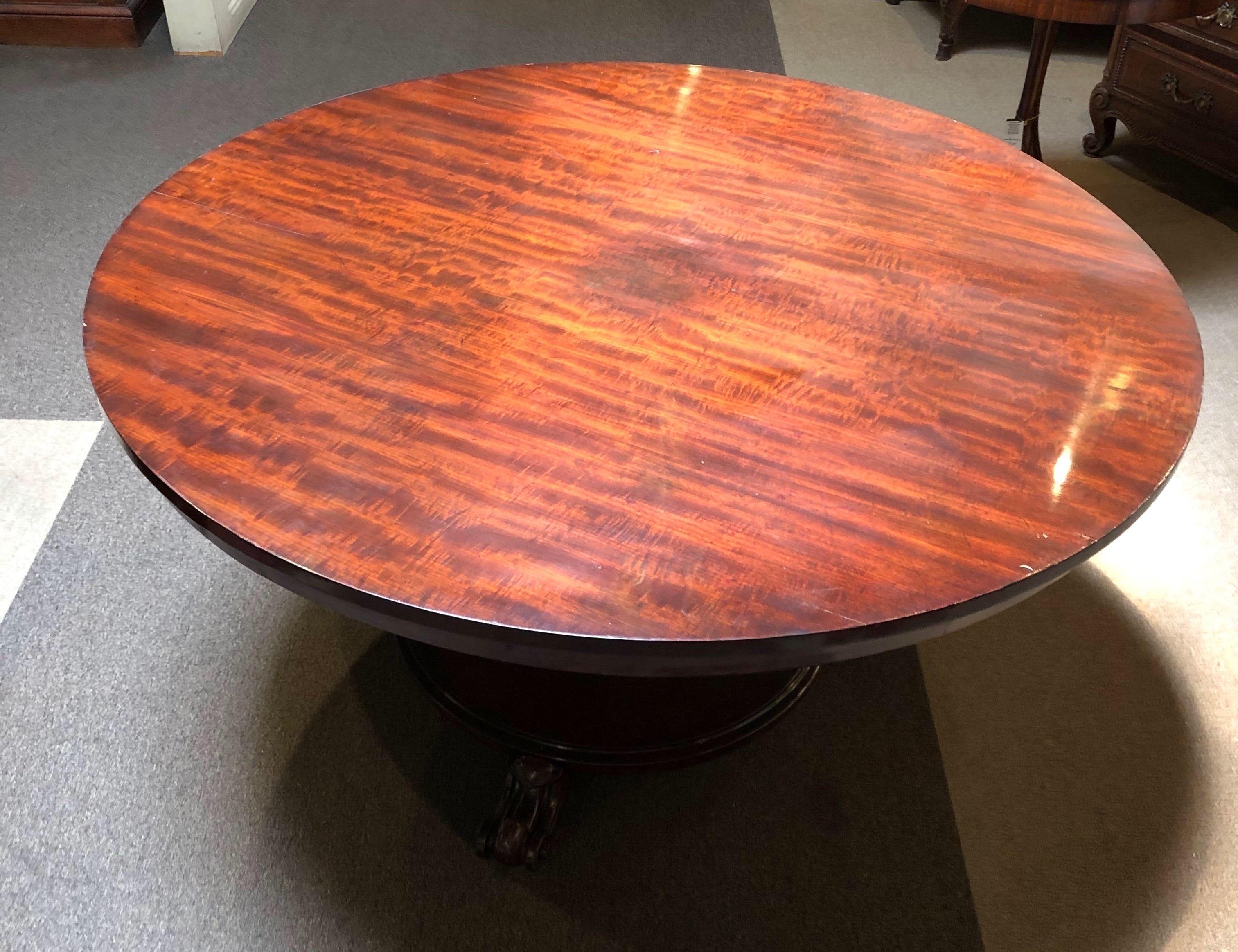 Great 19th century English mahogany table on a pedestal base with three carved feet. 


At 54