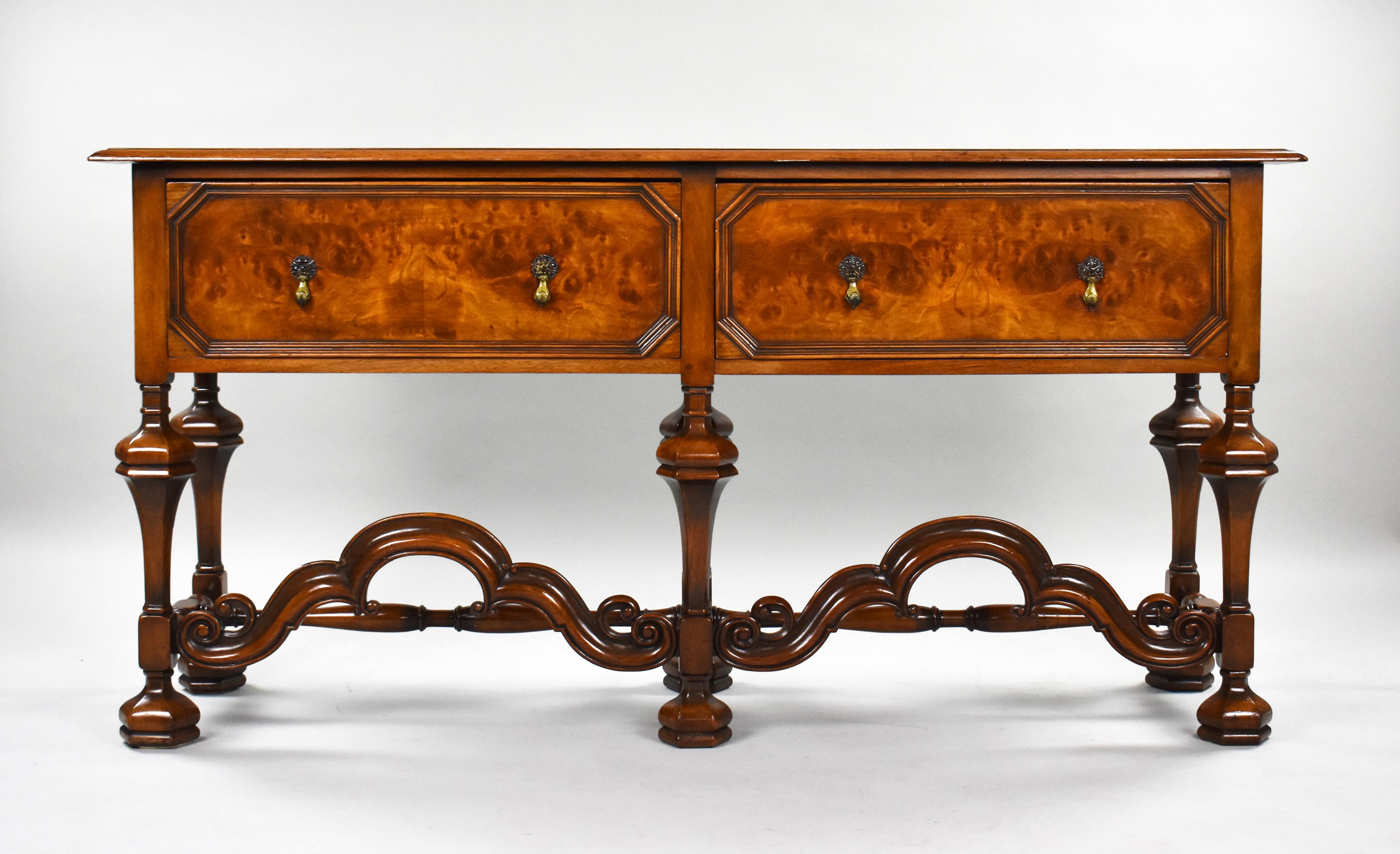 For sale is good quality William & Mary style walnut dresser base. Having two large burr walnut drawers, each with brass drop handles and brass escutcheons, standing on six legs united by turned stretchers. This piece remains in very good condition,