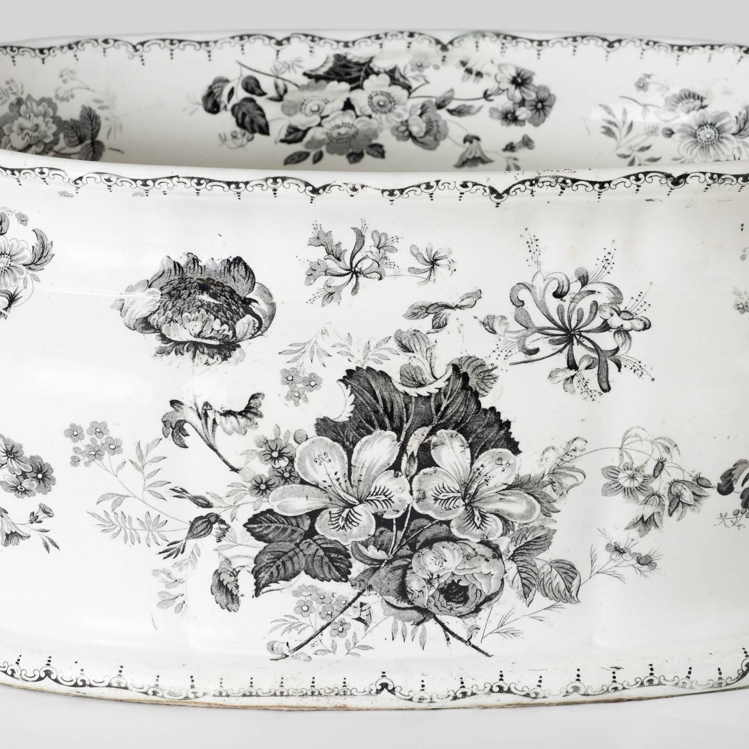 The monochrome colorings of this English transferware foot-tub give it a unique, one-of-a-kind look. The pattern name is stamped on the reverse and is called “Woodbine.” Flower decorations line the interior as well, circa 1850.

Measures: 8”