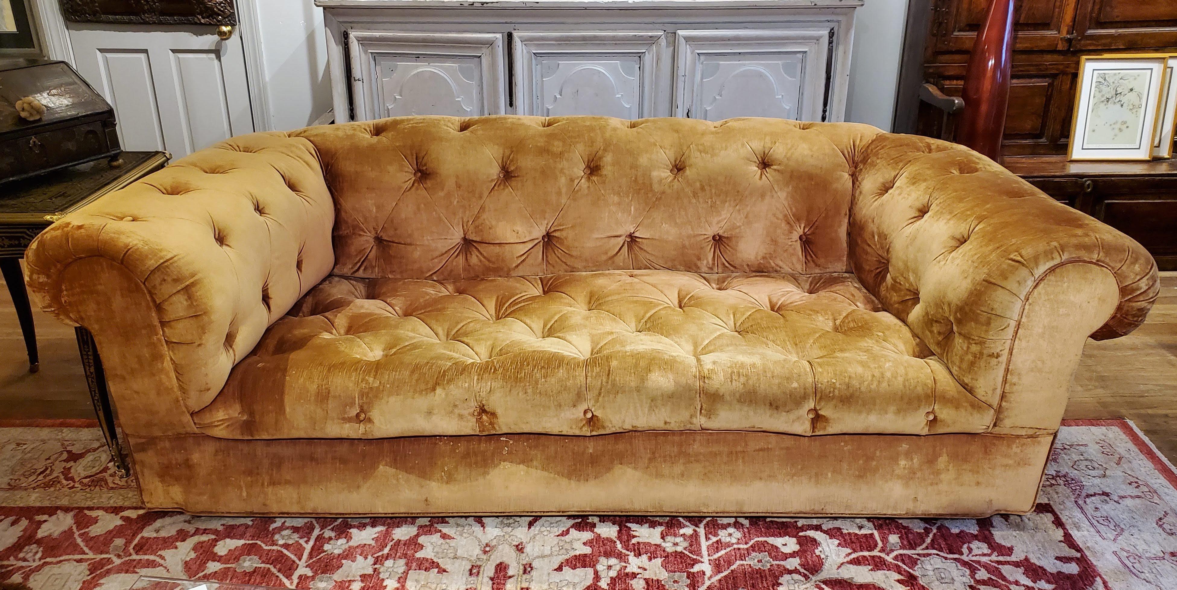This beautiful 19th century English yellow-gold velvet Chesterfield screams 