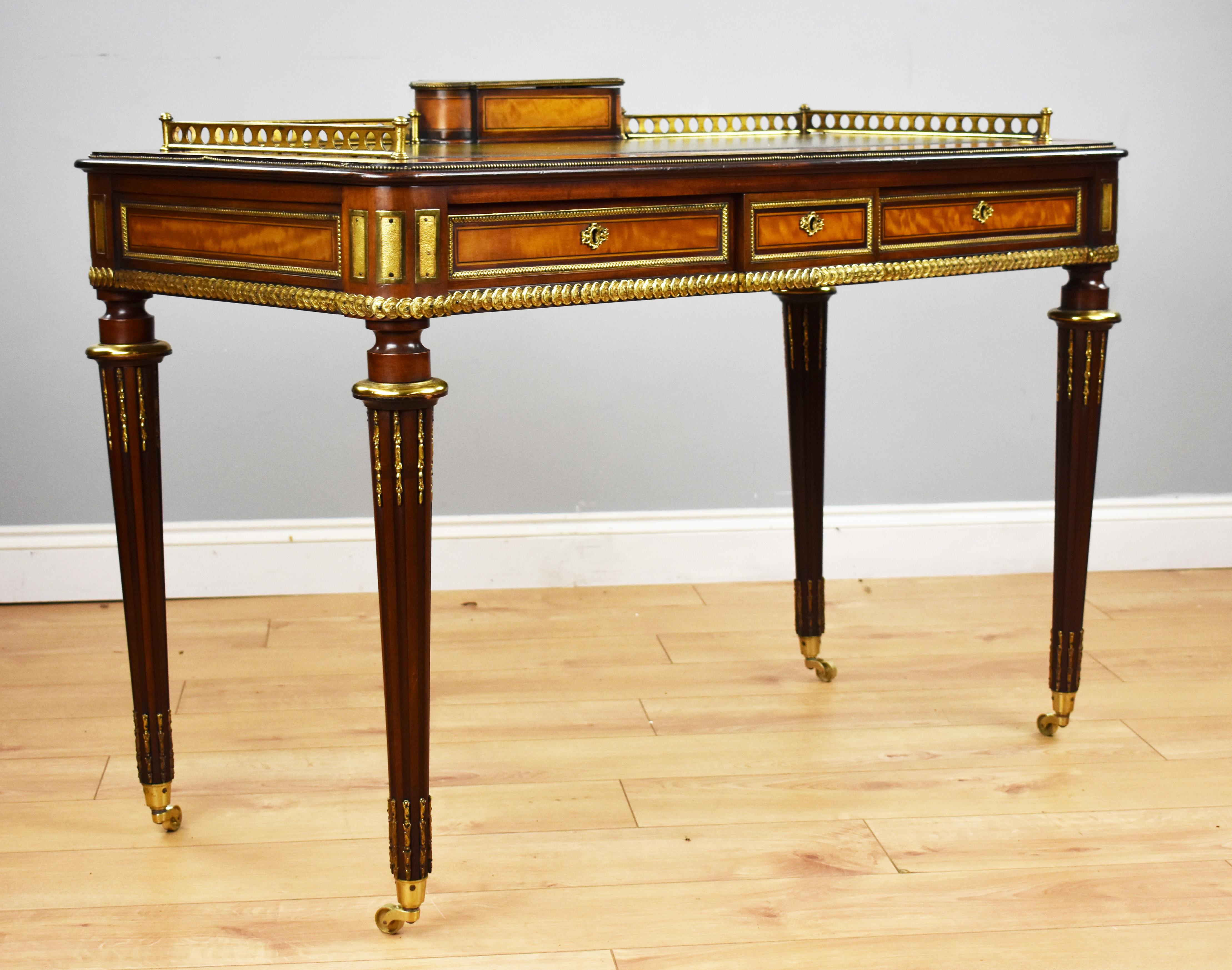 For sale is a top quality 19th century English Victorian mahogany and satinwood writing table stamped Edwards & Roberts. Being constructed from mahogany and fine satinwood the writing table has a writing utensil compartment, with perforated three