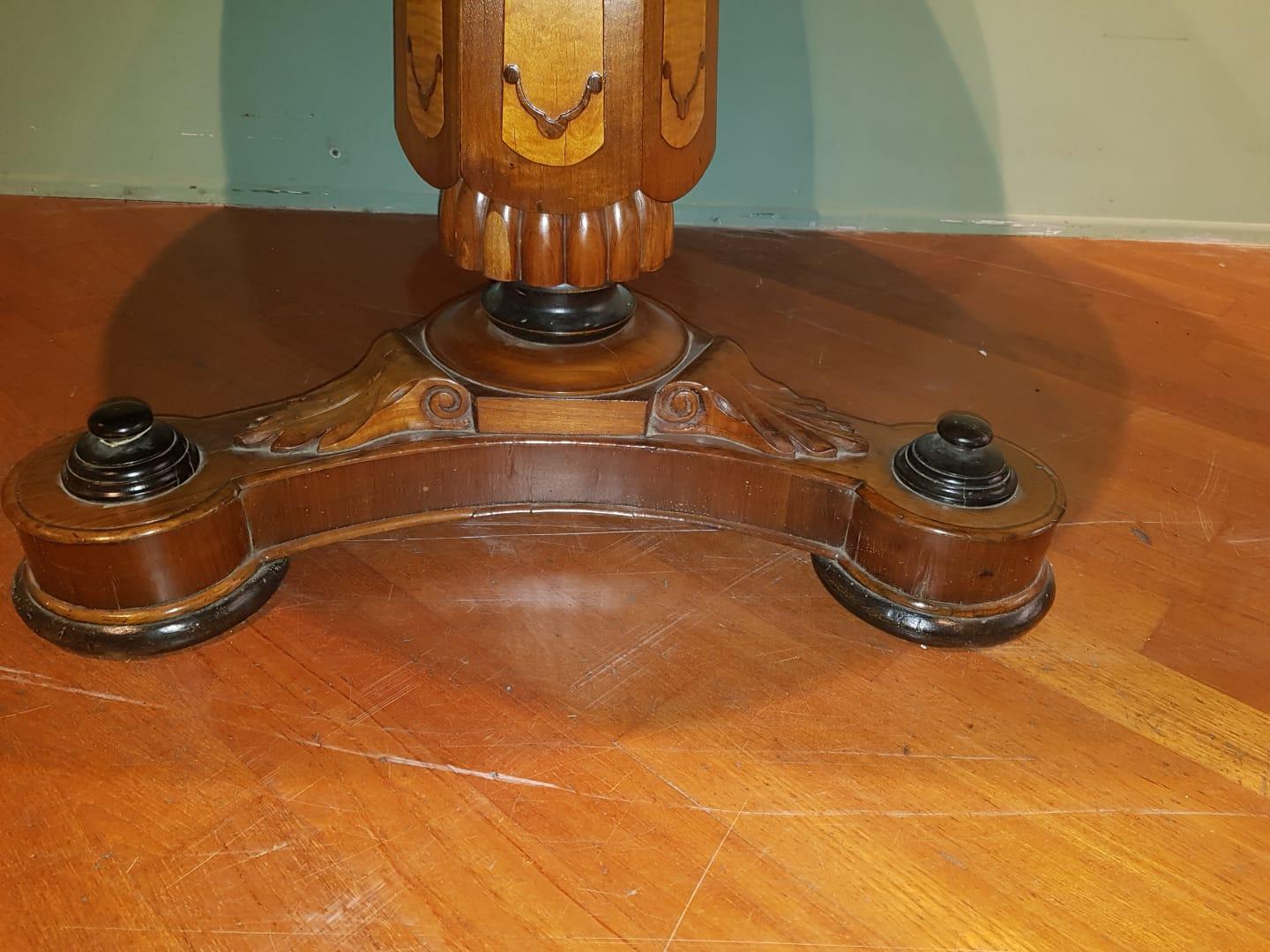 19th century engraved wood rounded marquinia marble-top table, France Charles X

19th century engraved rounded black marquinia marble-top table. From France from 19th century. The central leg is finely engraved with nut and other essences. The