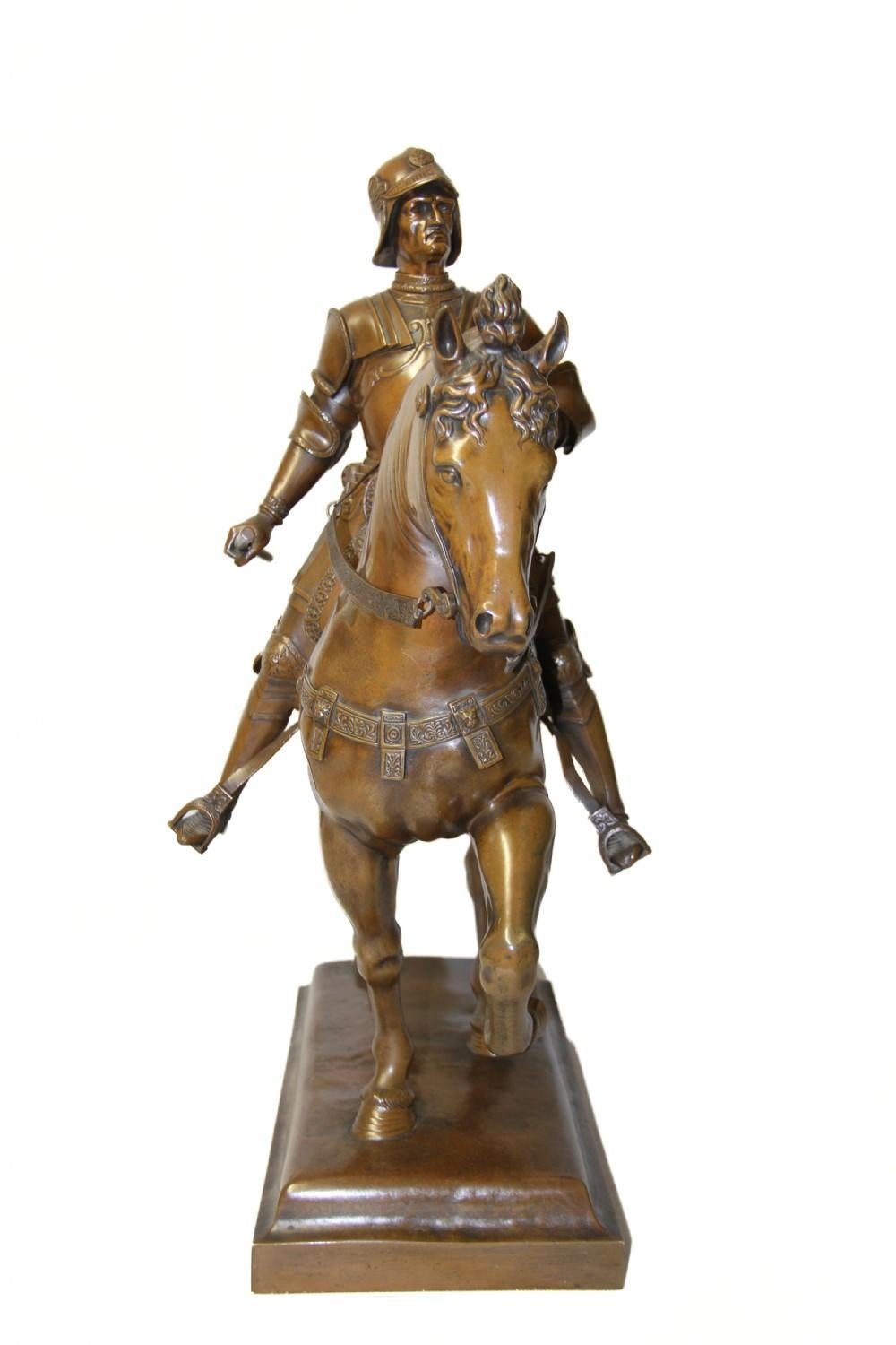 A superbly rendered and detailed sculpture depicting Bartolomeo Colleoni, commander of the Venetian Republic, on horseback with finely chased and decorated armour, holding the reins in one hand and a scroll in the other. He sits mounted on his