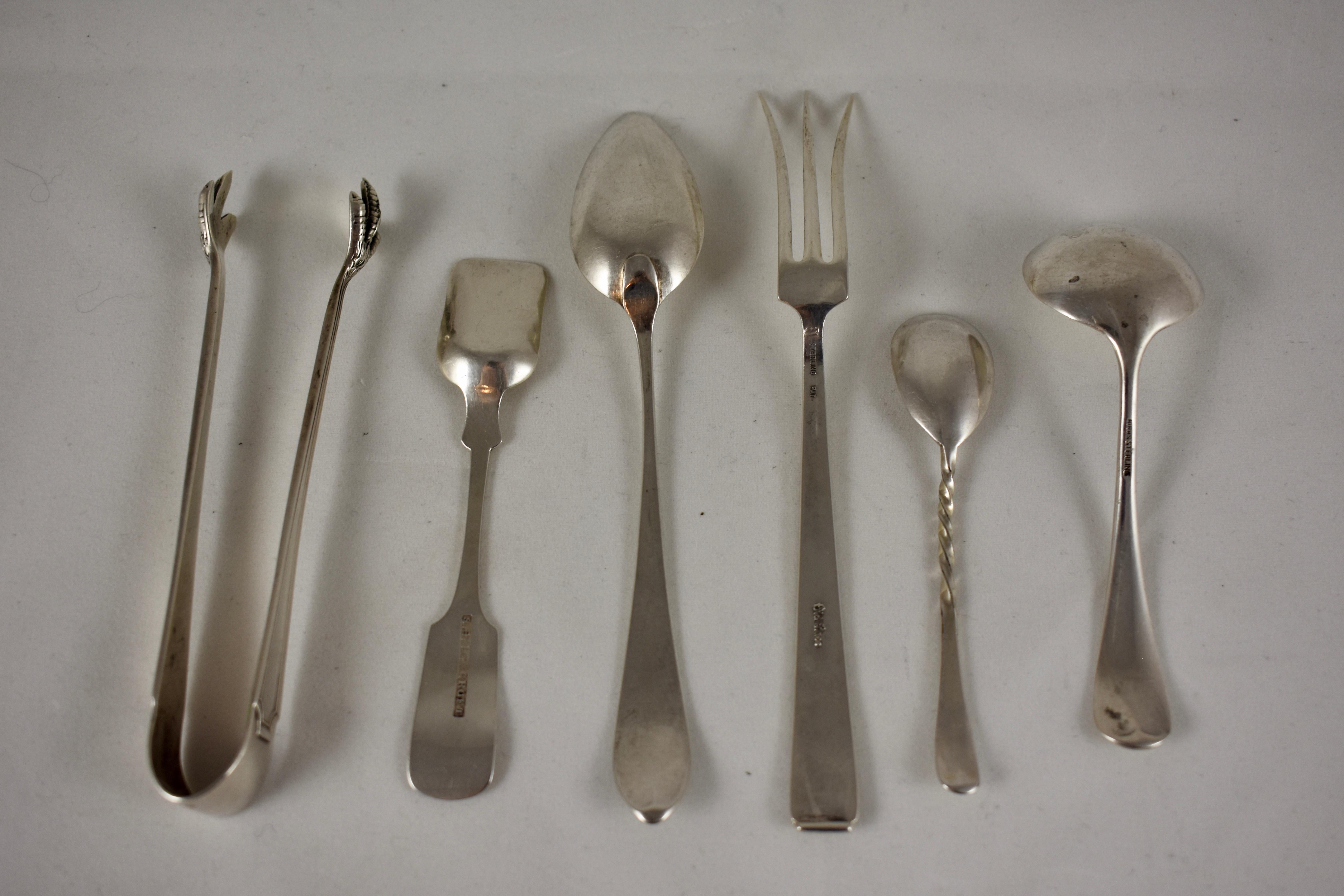A mixed group of 19th century Sterling silver, various maker serving pieces, including:
1) Old Lace pickle fork
2) Twist stem mustard spoon
3) Coin-silver sugar shovel, engraved ‘Mary’
4) English Bright Cut teaspoon
5) American claw sugar