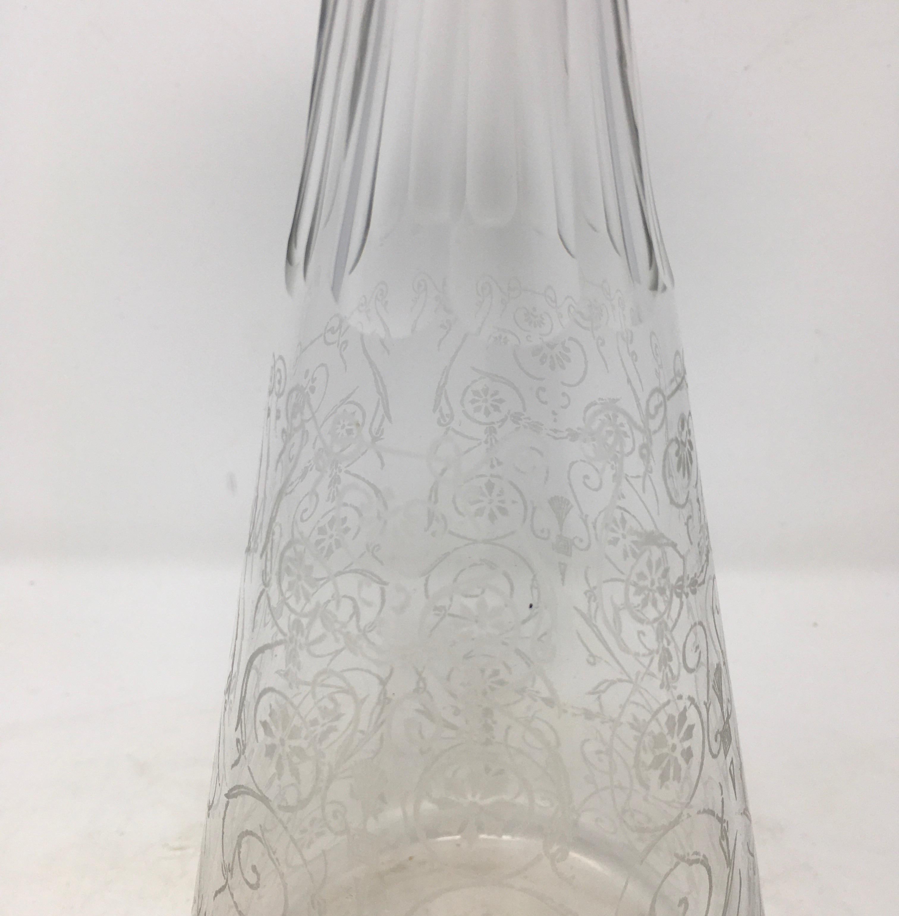 This is a beautiful English etched glass decanter. The decanter features intricate etched-glass work in a scroll pattern. A lovely piece for your bar or table.

This piece weighs 1.5 lb.