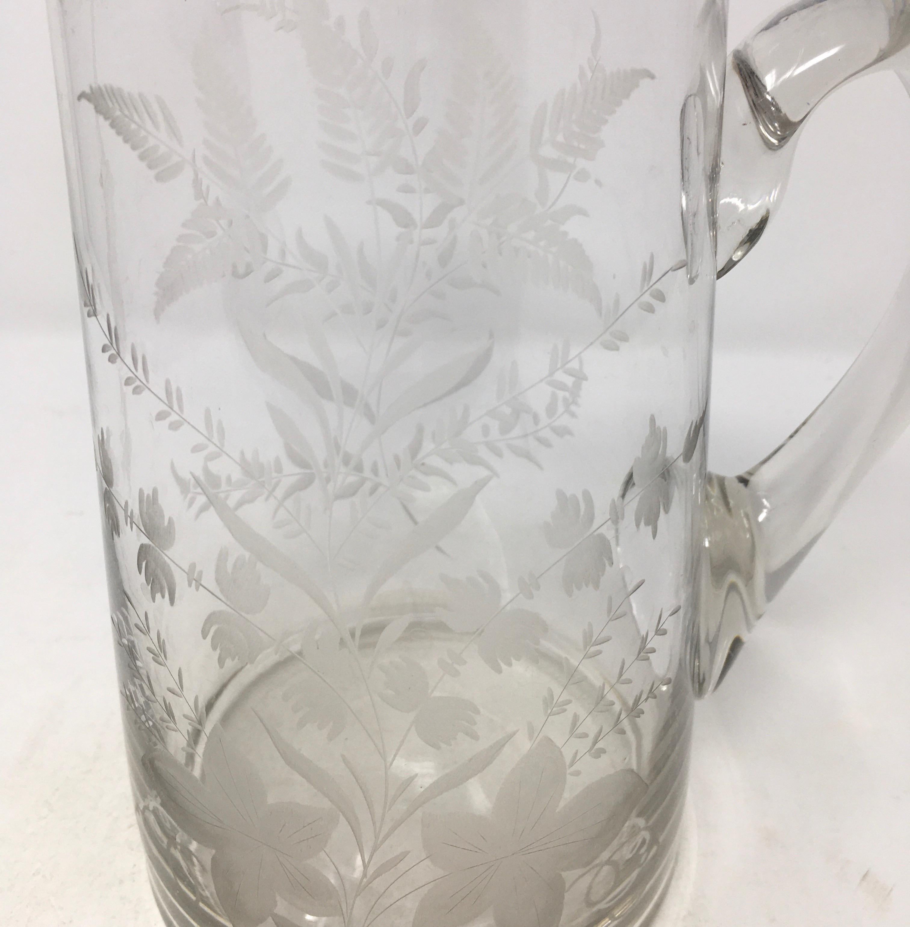 This is a beautiful English etched glass pitcher. The pitcher features intricate etched-glass work with flowers and ferns. A lovely piece for bedside or on the table.

This piece weighs 2 lbs.
