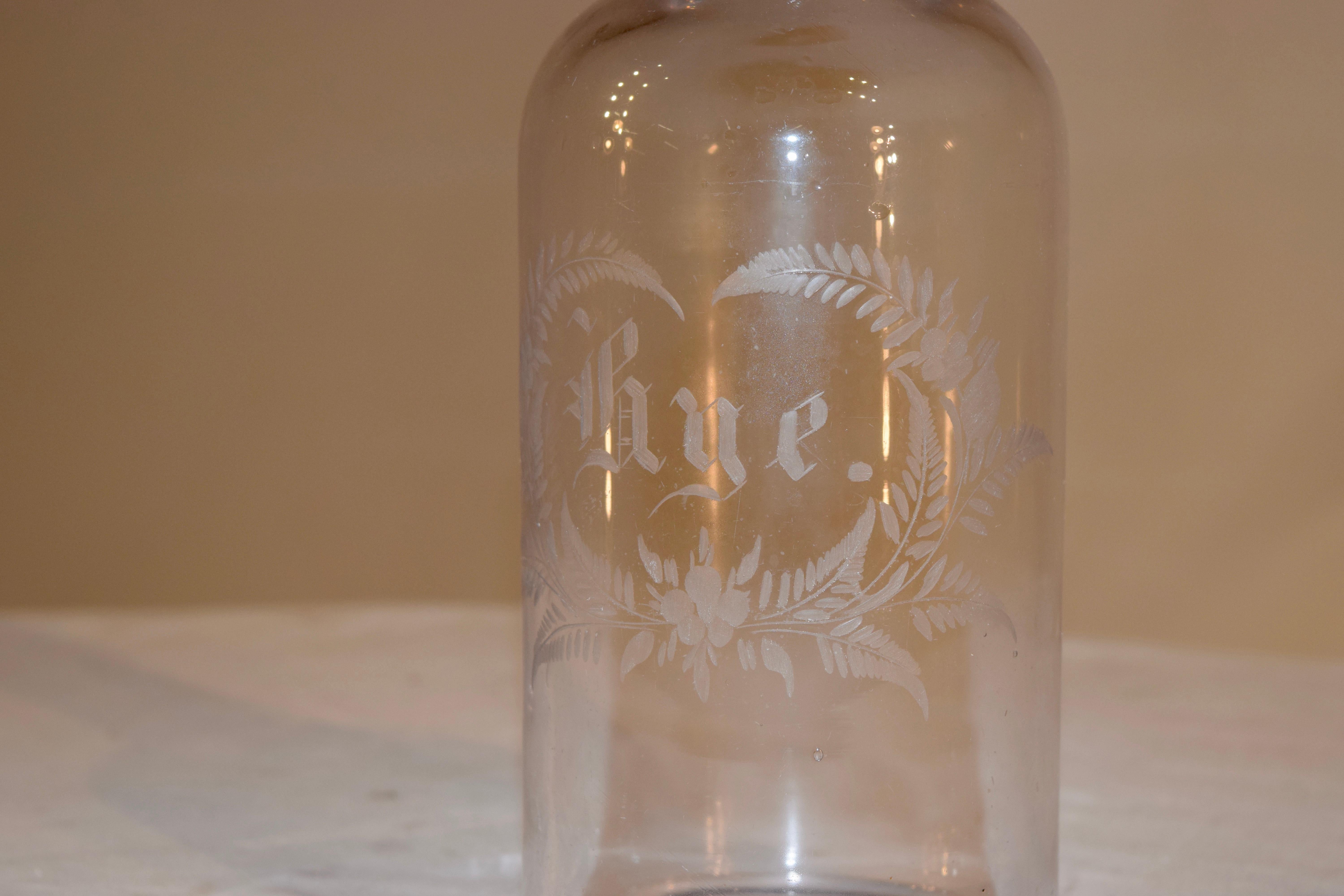 19th century English rye bottle from England which has a copper wheel etched design of a wreath of leaves surrounding the word rye. Lovely condition.