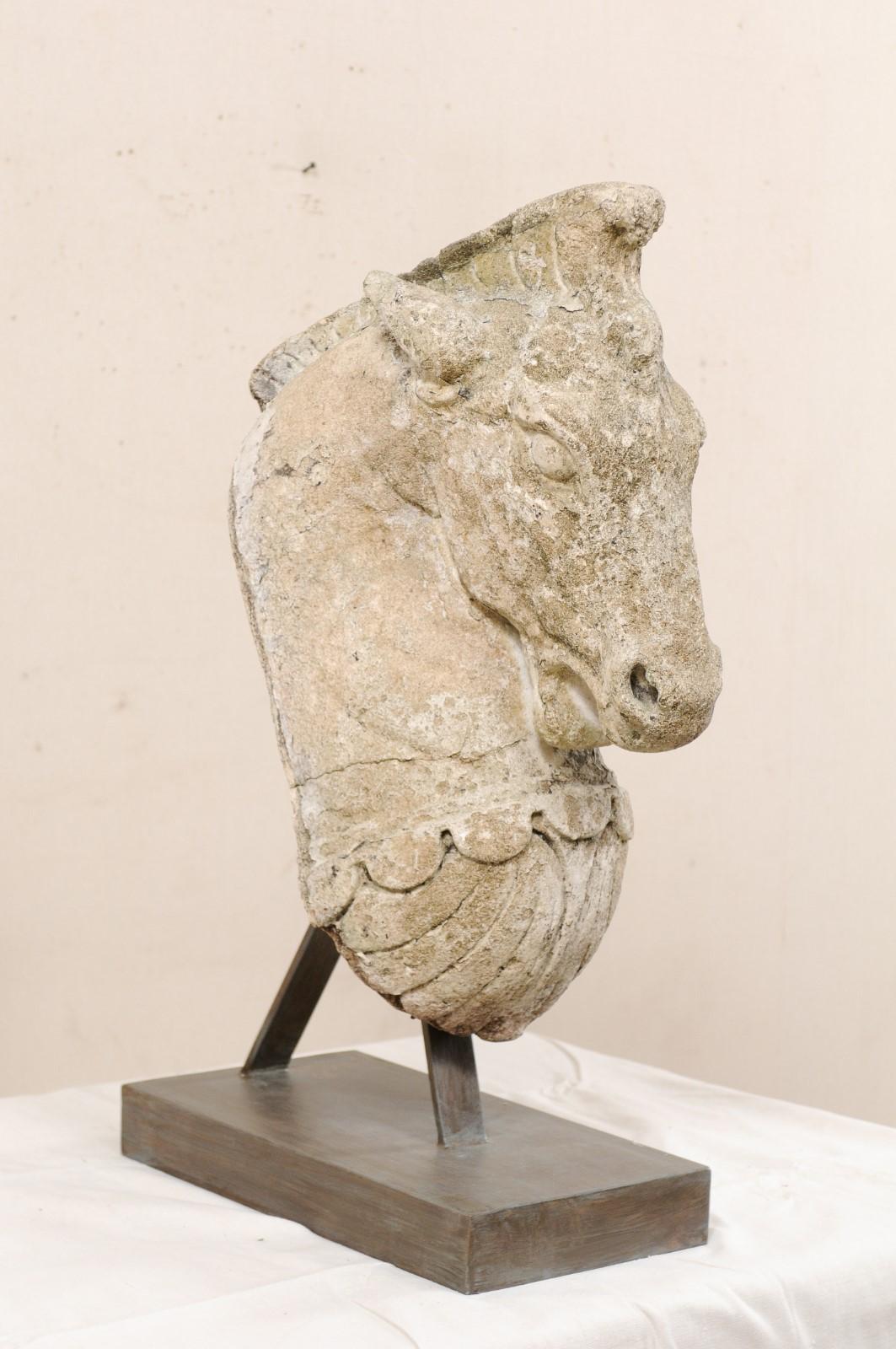 A 19th century European sculptural horse head of cast stone and mounted on custom stand. This fabulous art piece, standing just shy of 3 feet in height, has been custom fashioned from a 19th century cast-stone horse head, which was likely once a