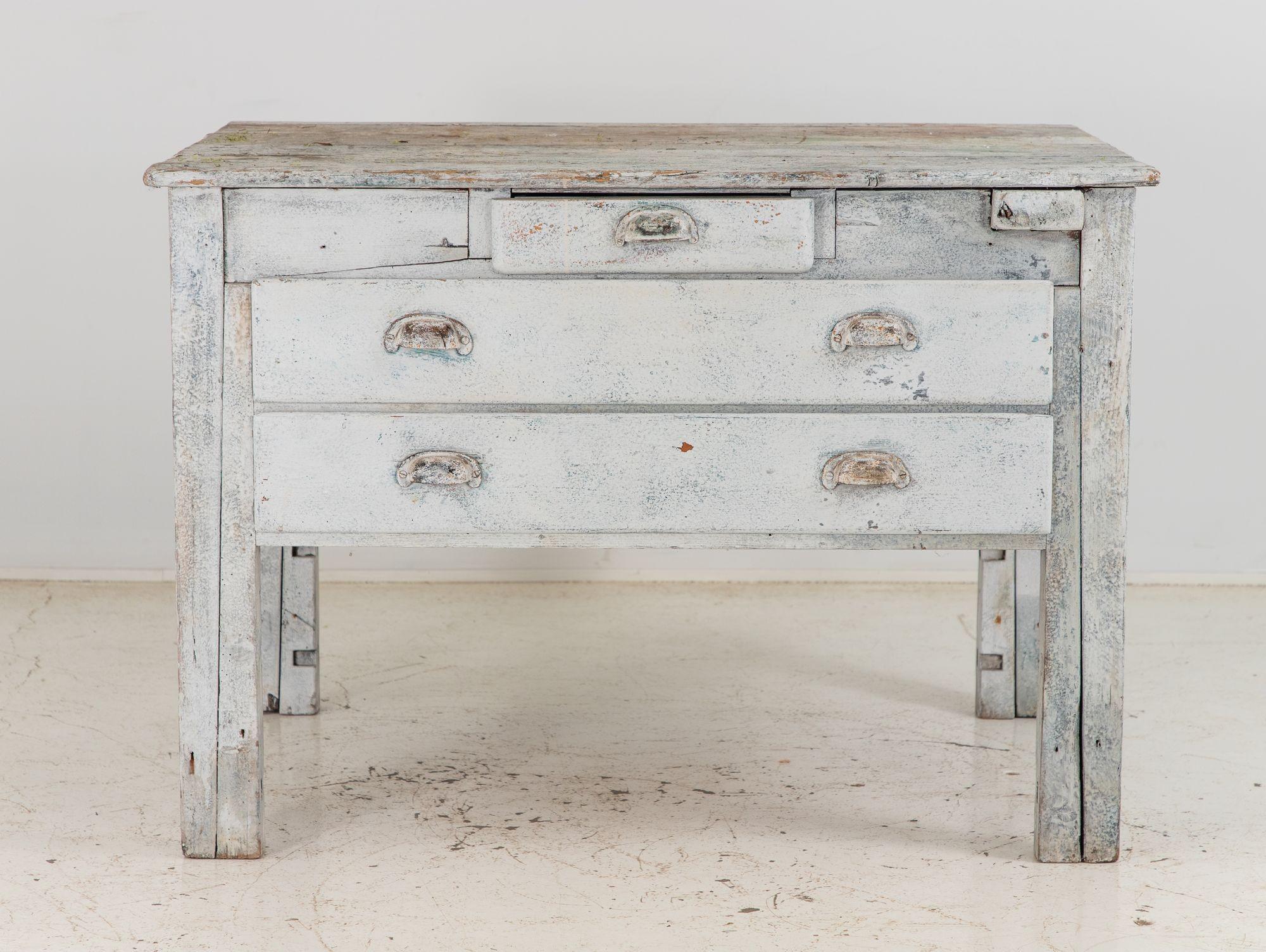 The 19th Century gray painted workbench is a versatile and practical addition to any space. Its sturdy construction ensures durability and reliability. The workbench features three drawers, each equipped with dividers for efficient organization. The