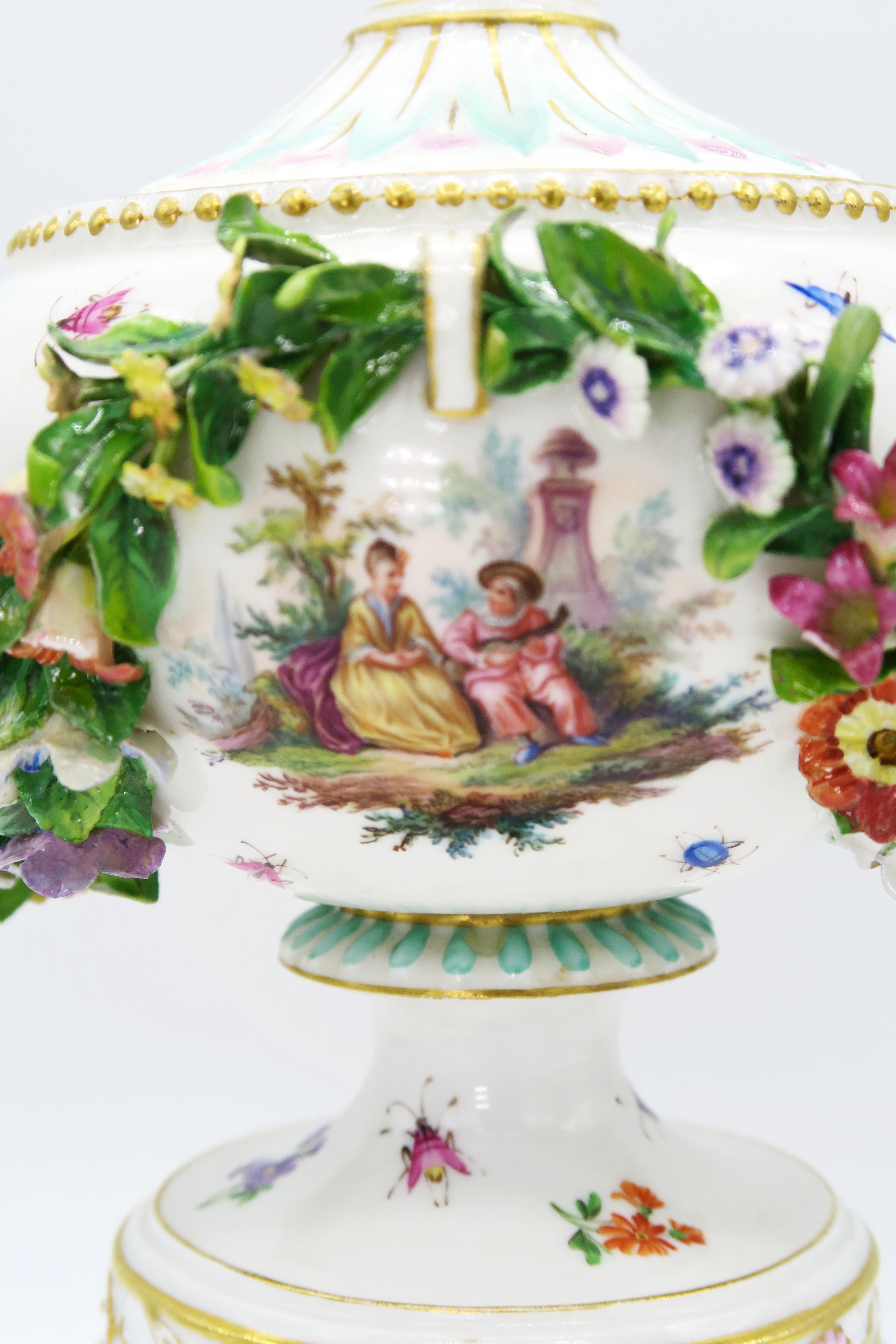 19th century European hand painted white Meissen porcelain vase on pedestal

Round foot, short shaft, hemispherical body, attached ear handles. Removable lid with large knob.
Wall on both sides on embossed flower garland in between 