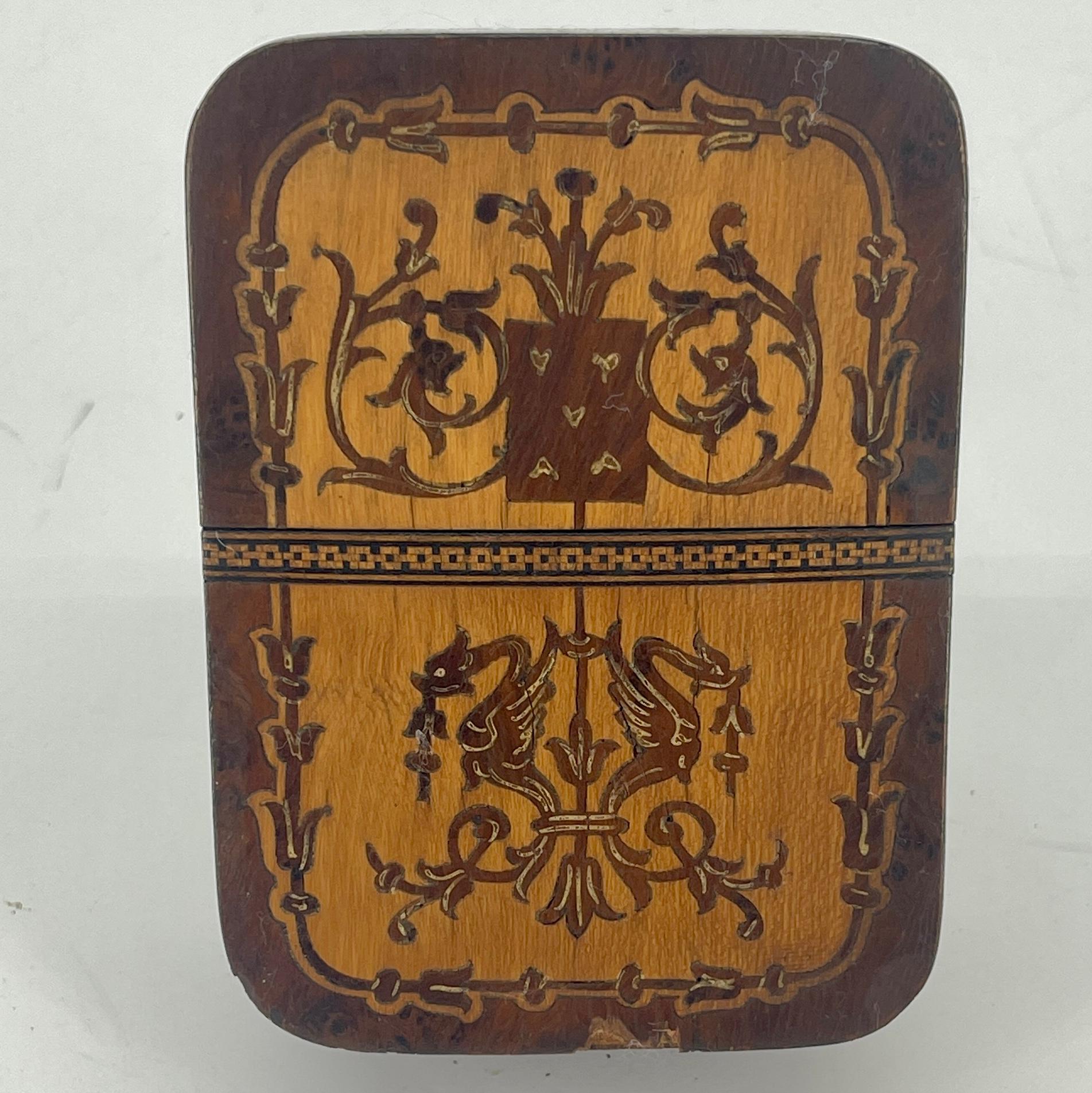 19th Century European Inlaid Game Box For Two Decks of Playing Cards.
The box is richly decorated with inlaid fruitwood and holds two set of playing cards.