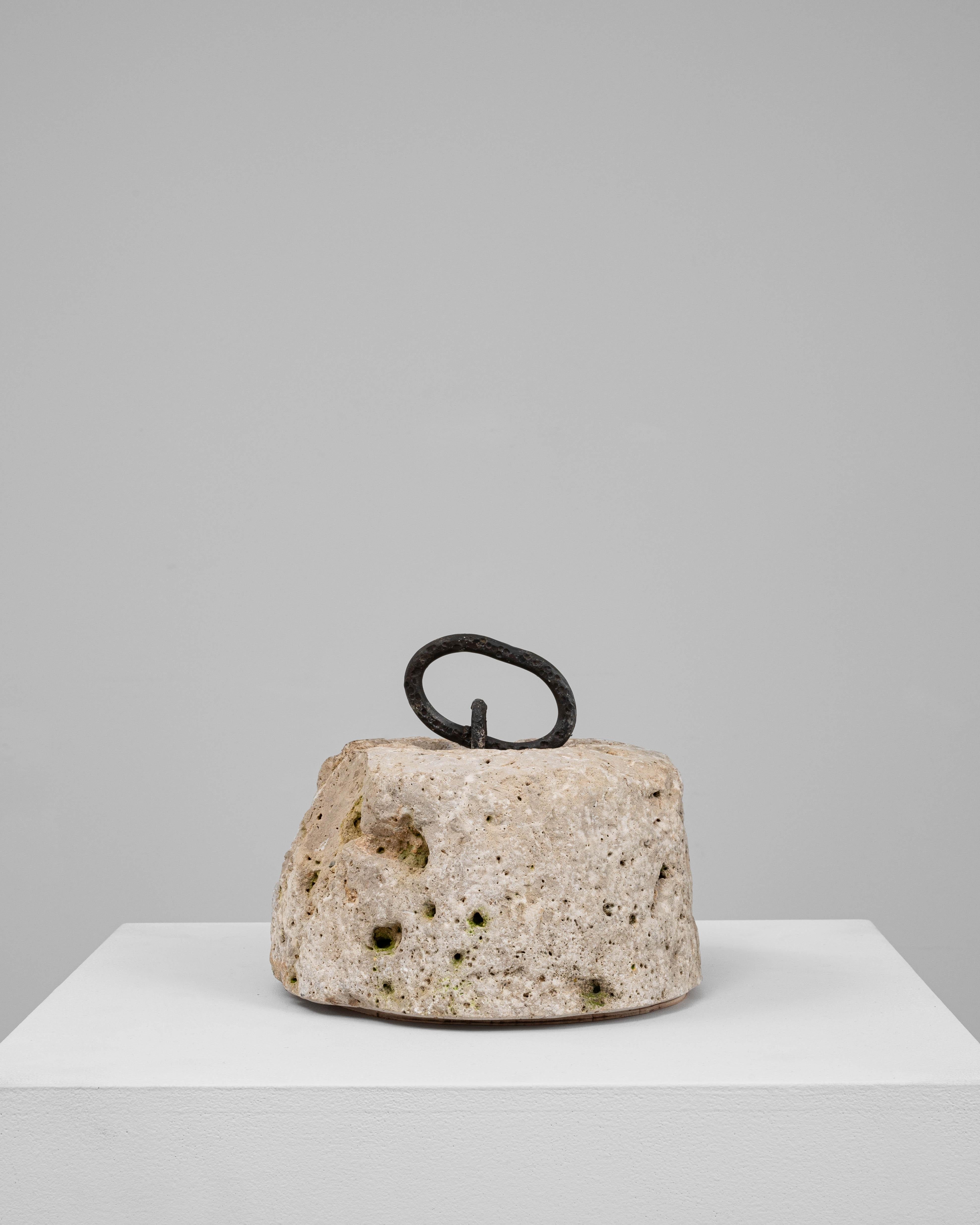 This 19th Century European marble door stop is a utilitarian object elevated by its natural material and sculptural presence. Hand-carved from porous, weathered marble, the piece exhibits a richly textured surface marked by pitting and subtle traces