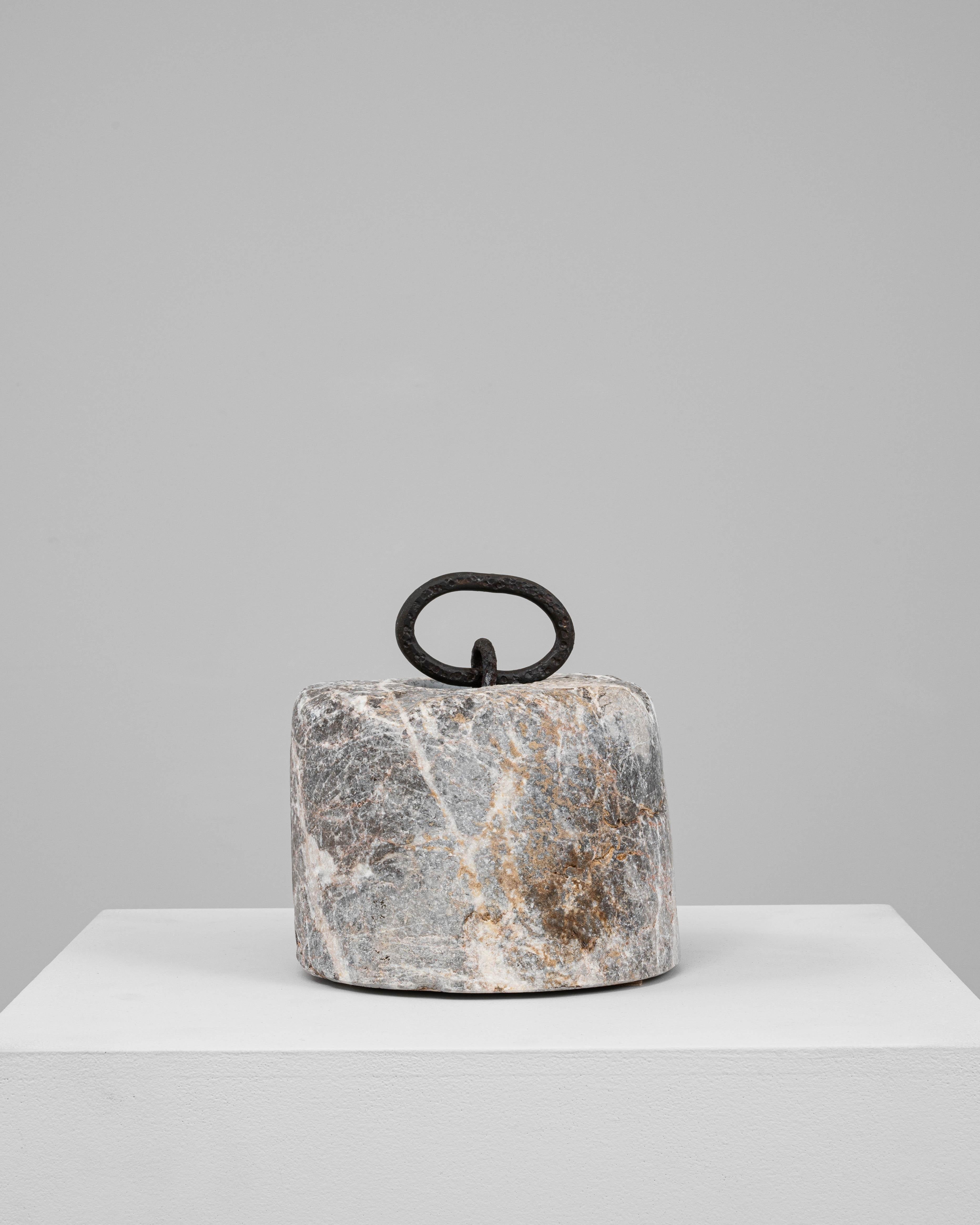 This 19th Century European marble door stop is a beautifully aged utilitarian object that doubles as a sculptural accent. Carved from richly veined marble in hues of gray, rust, and cream, the cylindrical form bears the subtle marks of time and use.