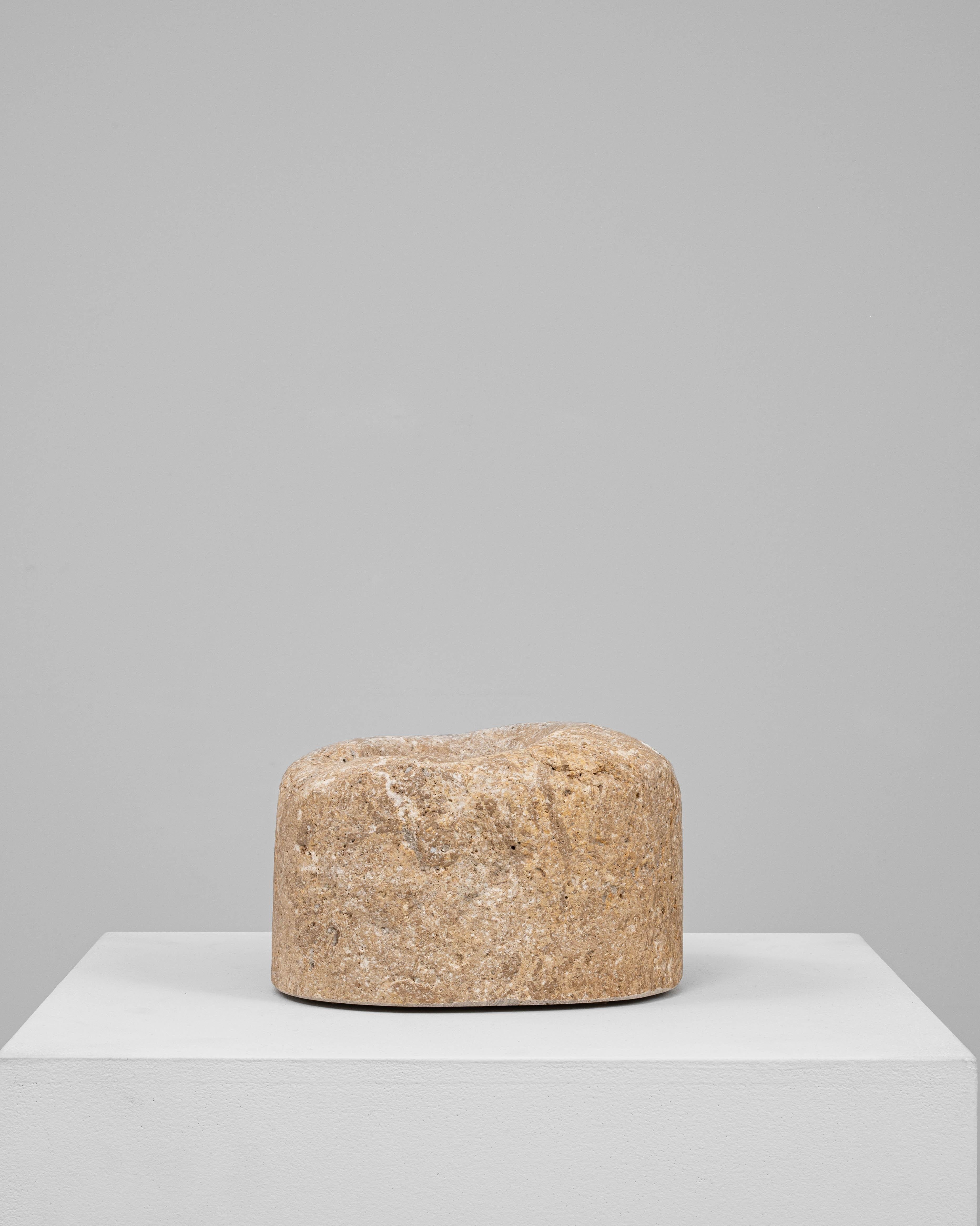 This 19th Century European marble mortar is a substantial and beautifully aged utilitarian object, hand-carved from dense, warm-toned stone. Its cylindrical form is softened by time and use, with a gently concave top bearing the natural wear of