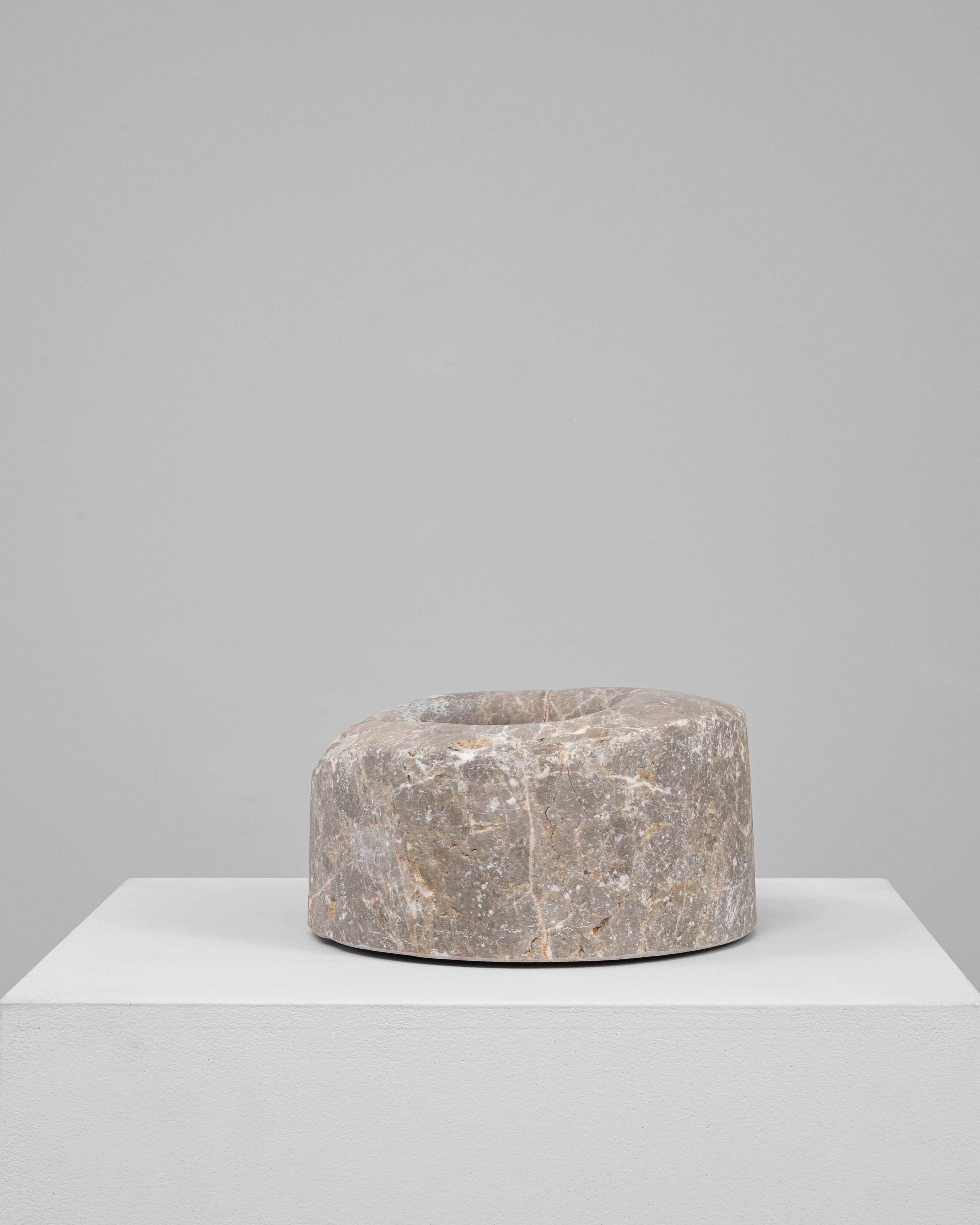 This 19th Century European marble mortar is a finely hand-carved piece that blends historic utility with sculptural elegance. Crafted from richly veined gray marble with streaks of warm ochre and white, the cylindrical form features a gently